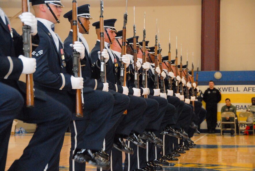 An audience at the Maxwell gym March 31 witnessed a first for the Air Force Honor Guard Drill Team as they performed high precision drills to a rock sound provided by Max Impact, an ensemble from the Air Force Band at Bolling Air Force Base, D.C.  Also from Bolling AFB, the drill team has been at Maxwell for the past month perfecting their routines for the upcoming performance season. (Air Force photo by Jamie Pitcher)
