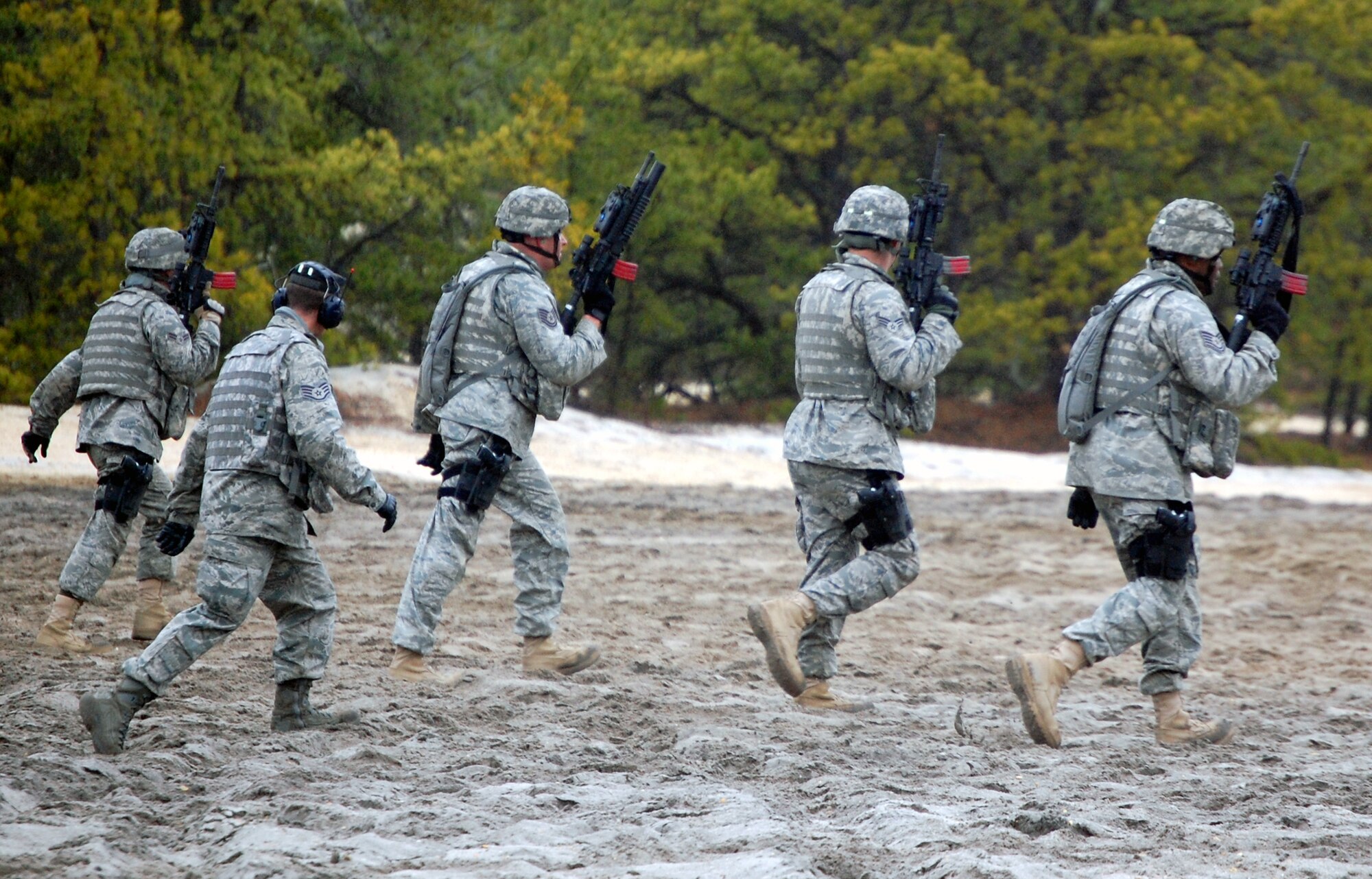 Security forces Airmen training for upcoming deployments move forward at a range on Fort Dix, N.J., on March 26, 2009, while participating in live-fire tactical shooting.  The training is provided by the U.S. Air Force Expeditionary Center's 421st Combat Training Squadron.  (U.S. Air Force Photo/Tech. Sgt. Scott T. Sturkol)