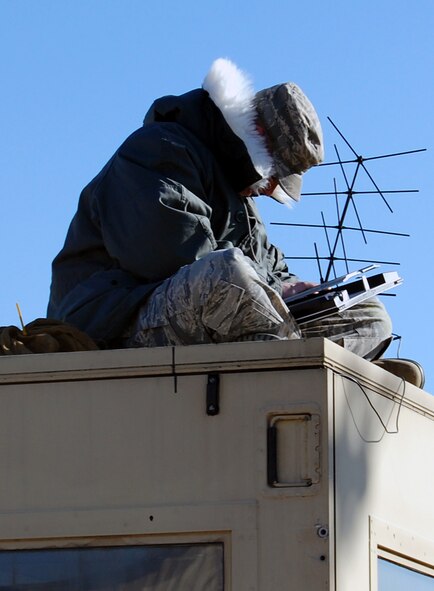 An instructor for the Mobility Operations School's Mobile Command, Control and Communications Leadership Course works on repairing equipment atop a mobile air shelter on Fort Dix, N.J., on March 24, 2009.  The Mobility Operations School is part of the U.S. Air Force Expeditionary Center on Fort Dix.  (U.S. Air Force Photo/Tech. Sgt. Scott T. Sturkol)