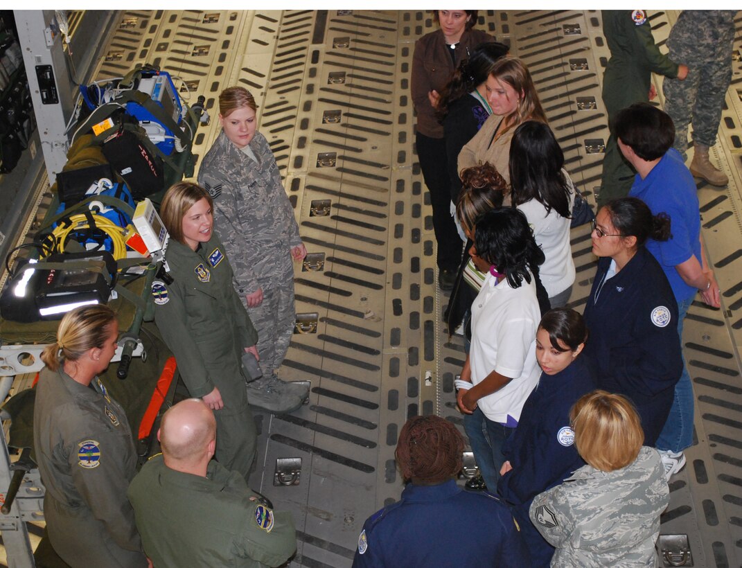 Students from Wando High School and Summerville High school listen to an aeromedical evacuation briefing during a tour of a static C-17 Globemaster III.  The students participated in the 2nd annual Women in Aviation Career Day hosted by the 315th Airlift Wing, Charleston AFB, S.C.  The day included a tour of a C-17 static display, Security Forces K-9 demonstration, aviation photographer with combat camera, aeromedical technicians, flying crew chiefs, avionics technicians, aerial porters, and airborne jumpers. (Air Force photo/Tanya Trejo)