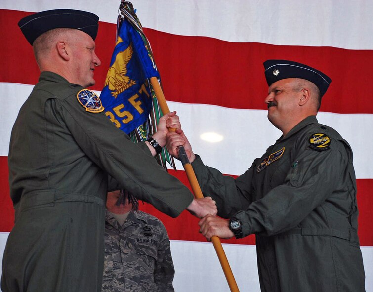 LAUGHLIN AIR FORCE BASE, Texas – Lt. Col. Richard Nesmith accepts the 85th Flying Training Squadron’s guidon from Col. Martin Schans, 47th Operations Group commander, during the change of command ceremony here March 27. Before Colonel Nesmith began to lead the squadron, a thank you and farewell was given to prior 85th FTS commander, Lt. Col. Christopher Stratton and his family. (U.S. Air Force photo by Airman 1st Class Sara Csurilla) 