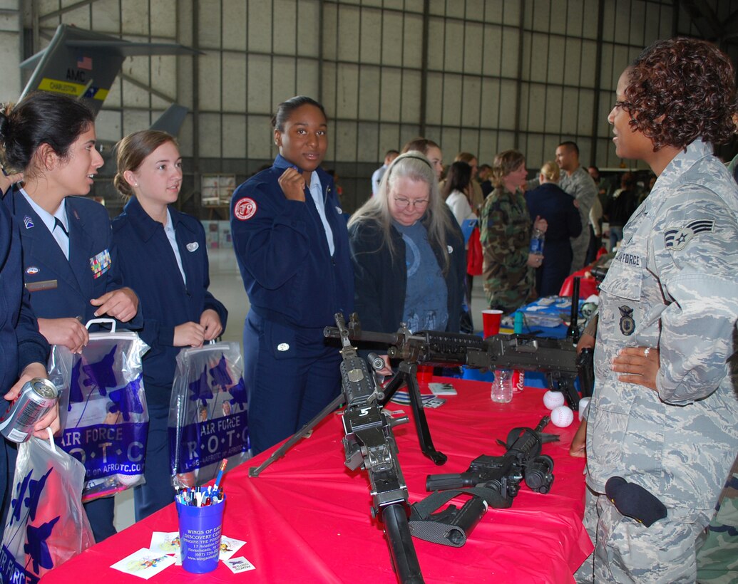 Students from Summerville High School visit the Security Forces table at the 2nd annual Women in Aviation Career Day hosted by the 315th Airlift Wing, Charleston AFB, S.C.  The day included a tour of a C-17 static display, Security Forces K-9 demonstration, aviation photographer with combat camera, aeromedical technicians, flying crew chiefs, avionics technicians, aerial porters, and airborne jumpers. (Air Force photo/Tanya Trejo)