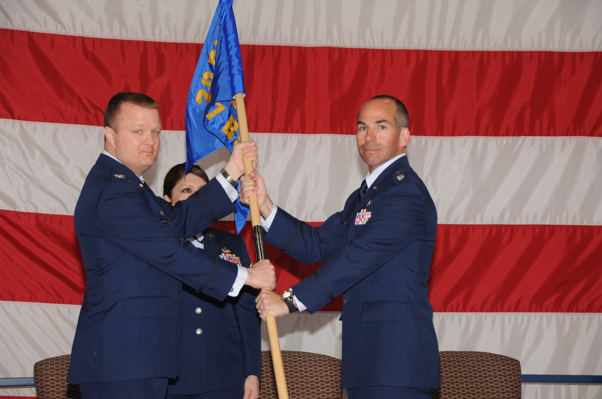 (Right to left) Lt. Col. Steven Biggs, 37th Bomb Squadron commander, receives the guidon from Col. Buck Shawhan, 28th Operations Group commander, taking command of the 37 BS here, April 2.  Colonel Shawhan officiated the 37 BS change of command ceremony. (U.S. Air Force photo/Senior Airman Anthony Sanchelli)