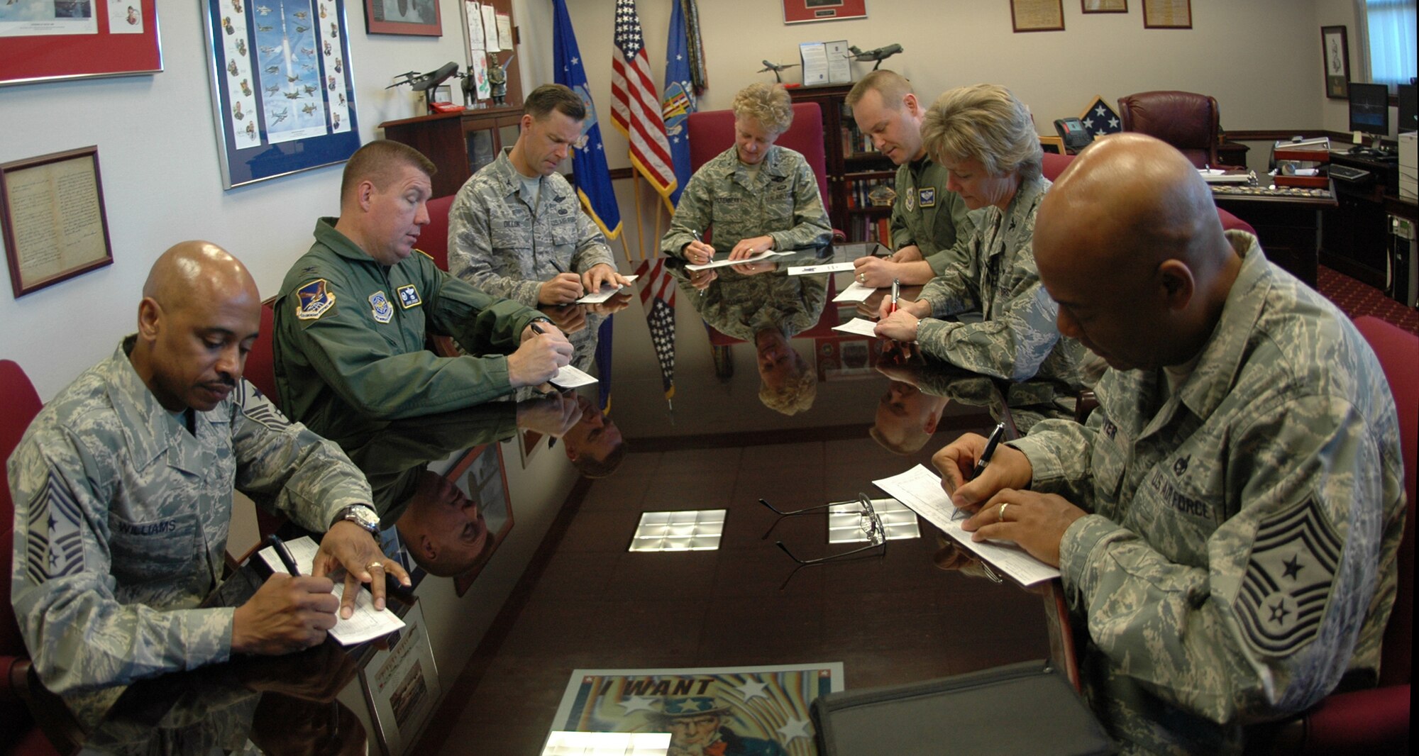 Clockwise from left, Chief Master Sgt. Michael Williams, 60th Air Mobility Wing command chief, Col. John Lipinski, 615th Contingency Response Wing commander,  Col. Mark Dillon, 60th AMW commander, Brig. Gen. Barbara Faulkenberry, 15th Expeditionary Mobility Task Force commander, Maj. Daryl Myers, Travis’ Air Force Assistance Fund installation project officer, Col. Maryanne Miller, 349th AMW commander and Chief Master Sgt. Ray Weaver, 615th CRW command chief make donations to the 2009 AFAF campaign in the 60th AMW headquarters building April 1. (U.S. Air Force photo/Staff Sgt. Shaun Emery)