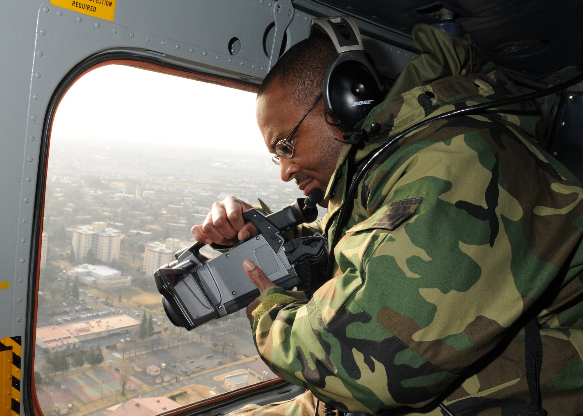 Master Sgt. Joseph Hudson, 374th Civil Engineer Squadron infrastructure superintendent, uses an infrared camera March 17 to detect leaks in the heat distribution system at Yokota Air Base, Japan.  Pilots from the 459th Airlift Squadron flew Sergeant Hudson on six missions aboard UH-1N helicopters to take video of the entire distribution system. (U.S. Air Force photo/Airman Sean Martin)