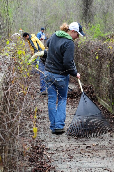 Trail restoration volunteers rake leaves from a bridge along the Big Tree Hiking Trail. (U.S. Air Force photo by Senior Airman Joanna M. Kresge) 