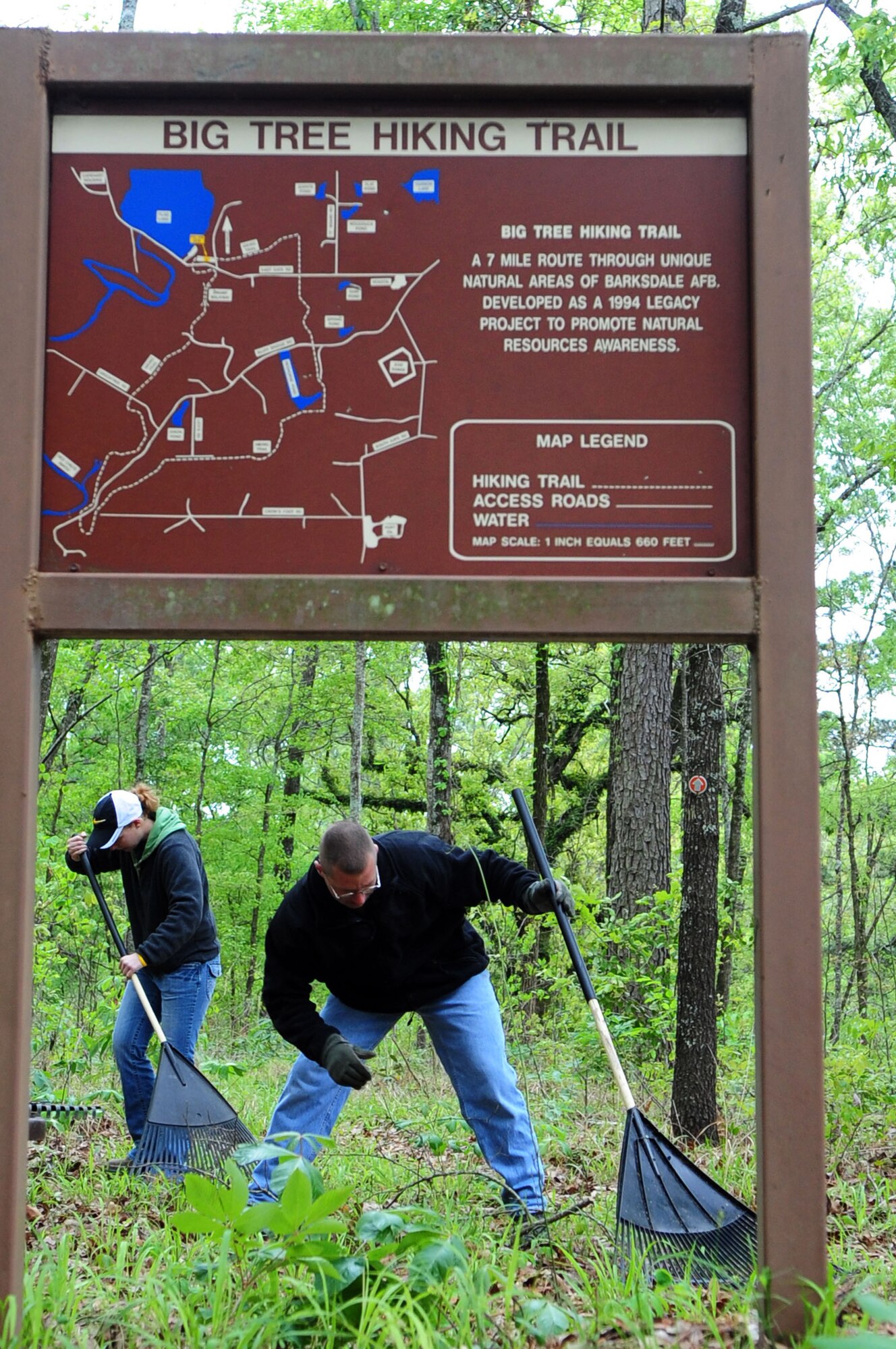 Trail restoration volunteers clear the trail head picnic area of the Big Tree Hiking Trail. (U.S. Air Force photo by Senior Airman Joanna M. Kresge)