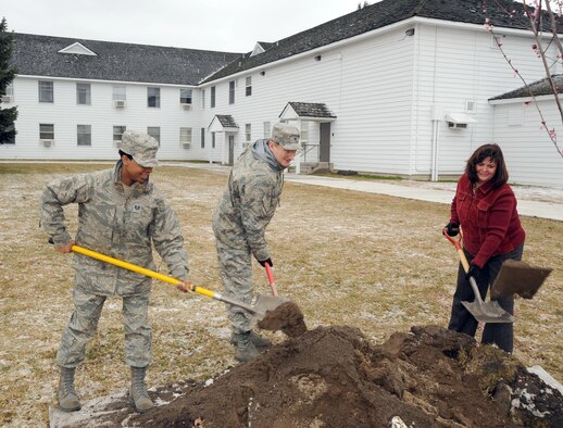 Col. Robert Thomas, 92nd Air Refueling Wing commander, Bo Smith, chief wing protocol and Tech. Sgt. Teresa Tillman, protocol also from the 92nd ARW, plants a tree at Fairchild’s white house. The tree planting ceremony took place on April 1 and celebrates Arbor Day, which is a nationally recognized observance that encourages tree planting and care. Fairchild was also named a Tree City USA community by the Arbor Day Foundation to honor its commitment to community forestry. This is Fairchild’s 15th year being recognized with this national recognition. Fairchild also received this award for demonstrating progress in its community forestry program in the following area: Planning and management, tree inventory and analysis, park and open space.  (U.S. Air Force photo / Staff Sgt JT May III)