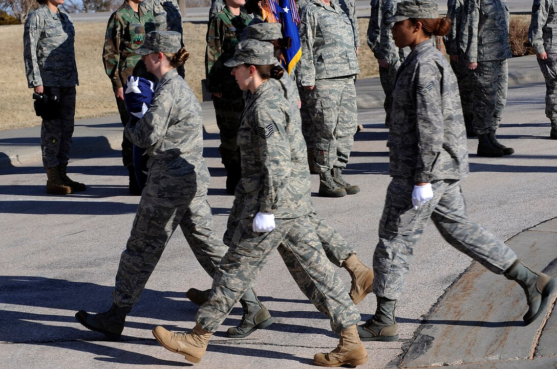 A group of female Airmen secure the flag during a retreat ceremony, March 27. The Airmen represent servicewomen, past and present, in the U.S. military. Women's History Month is celebrated in March to increase consciousness and knowledge of the contributions made by women.  (U.S. Air Force photo/Senior Airman Marc I. Lane)