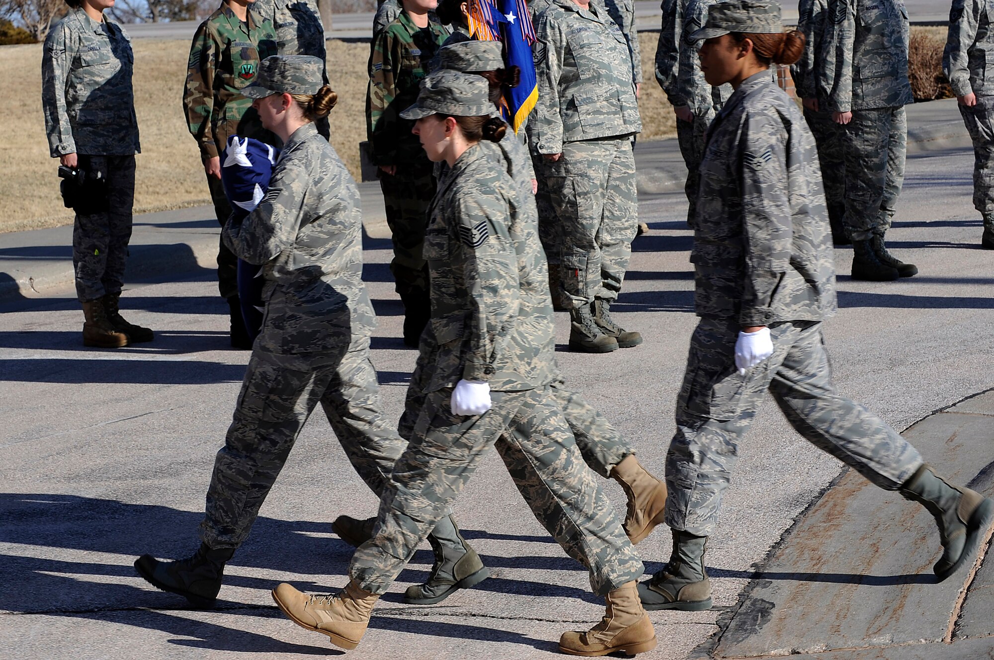A group of female Airmen secure the flag during a retreat ceremony, March 27. The Airmen represent servicewomen, past and present, in the U.S. military. Women's History Month is celebrated in March to increase consciousness and knowledge of the contributions made by women.  (U.S. Air Force photo/Senior Airman Marc I. Lane)