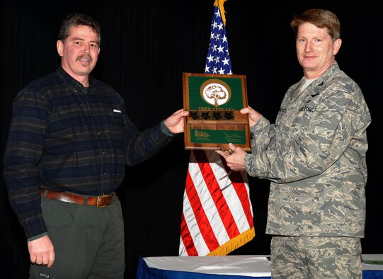 Col. Robert Thomas, 92nd Air Refueling Wing commander, receives award a Tree City USA award from Jim Flott, Department of Natural Resources. This is Fairchild’s 15th year being recognized with this national recognition. Fairchild also received this award for demonstrating progress in its community forestry program in the following area: Planning and management, tree inventory and analysis, park and open space.  (U.S. Air Force photo / Staff Sgt JT May III)