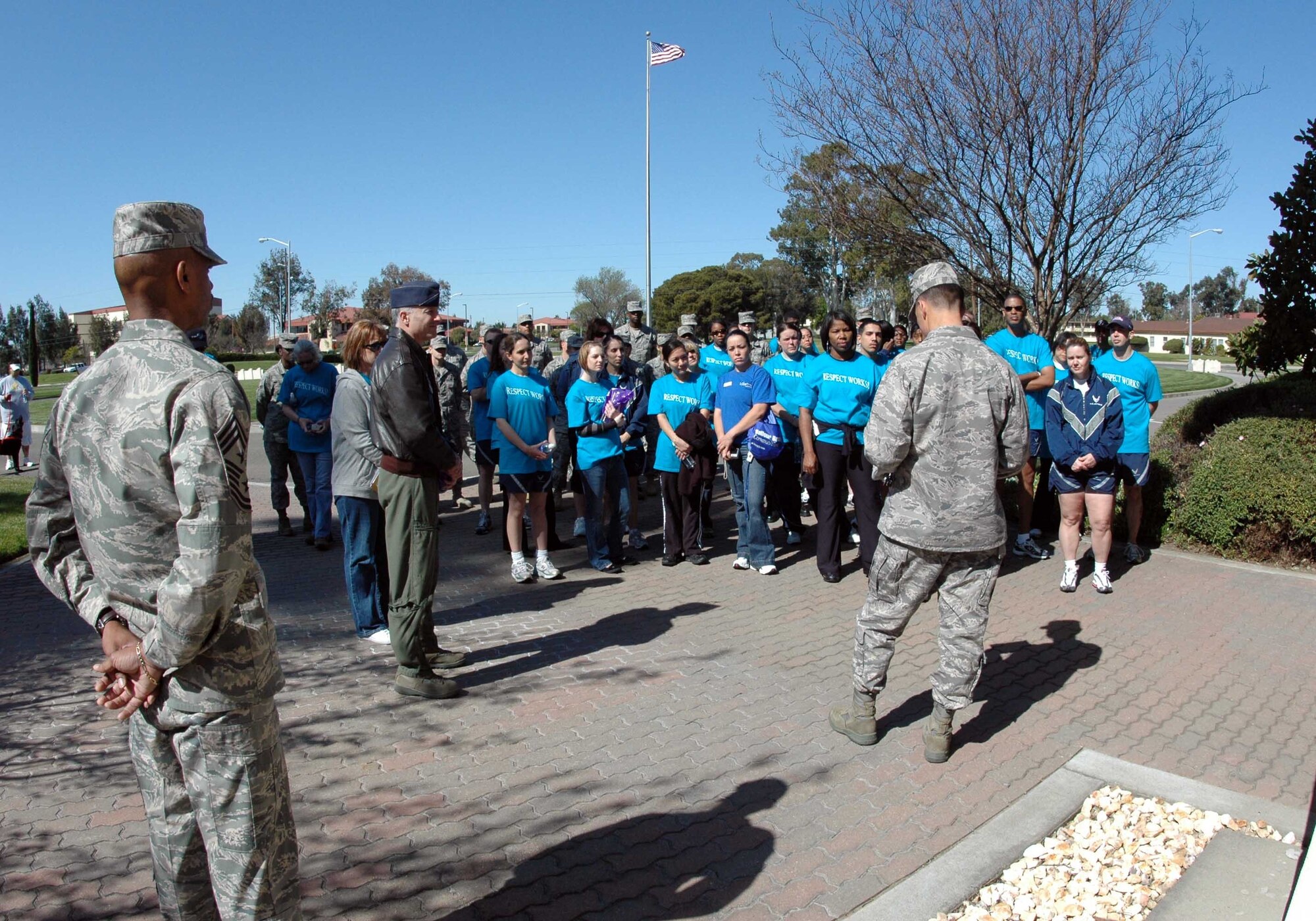Col. Mark Dillon, 60th Air Mobility Wing commander, (center foreground), reads the Sexual Assault Awareness Month Proclamation after completeing the SAAM Walk along with other Team Travis members April 2. The walk which began at the Base Theater, is an opportunity to raise awareness about sexual assault. (U.S. Air Force photo/Senior Airman Kristen Rohrer)