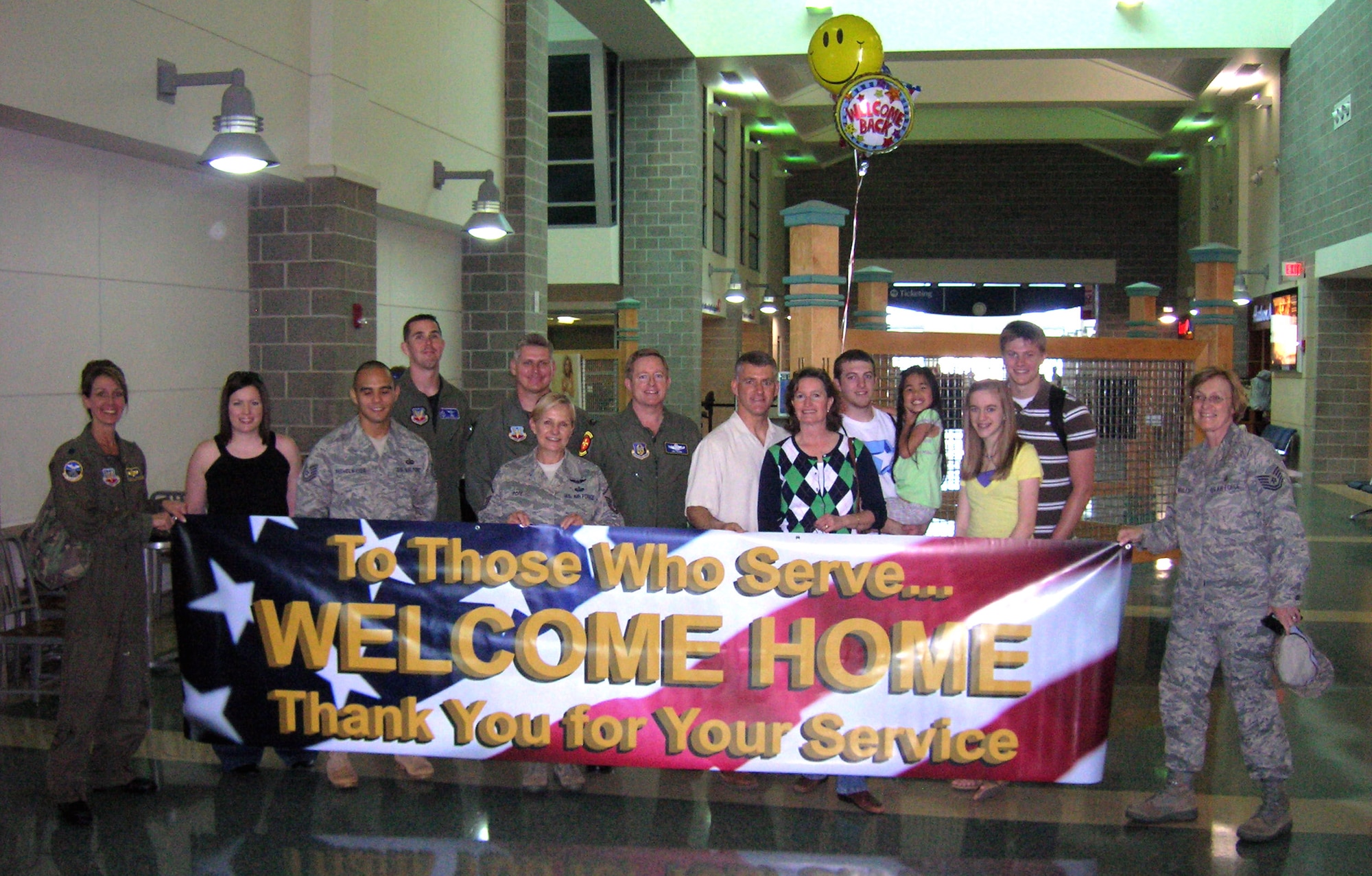Members of the 706th Fighter Squadron Detachment 1, Hurlburt Field, Fla., wait with a new banner at the Northwest Florida Regional Airport to welcome home Lt. Col. Jim Marshall from his six-month tour in Iraq. Colonel Marshall and 706th FS, Det 1 reservists are fully integrated into regular Air Force operations at Hurlburt Field. The welcome home banner is planned to be erected in the airport lobby. "The civilian-military ties in the Fort Walton Beach area are exceptional, and this banner is merely one example of the extraordinary support the local community here gives its military population" said Lt. Col. Patrick Ryan, 706th FS, Det 1 commander.