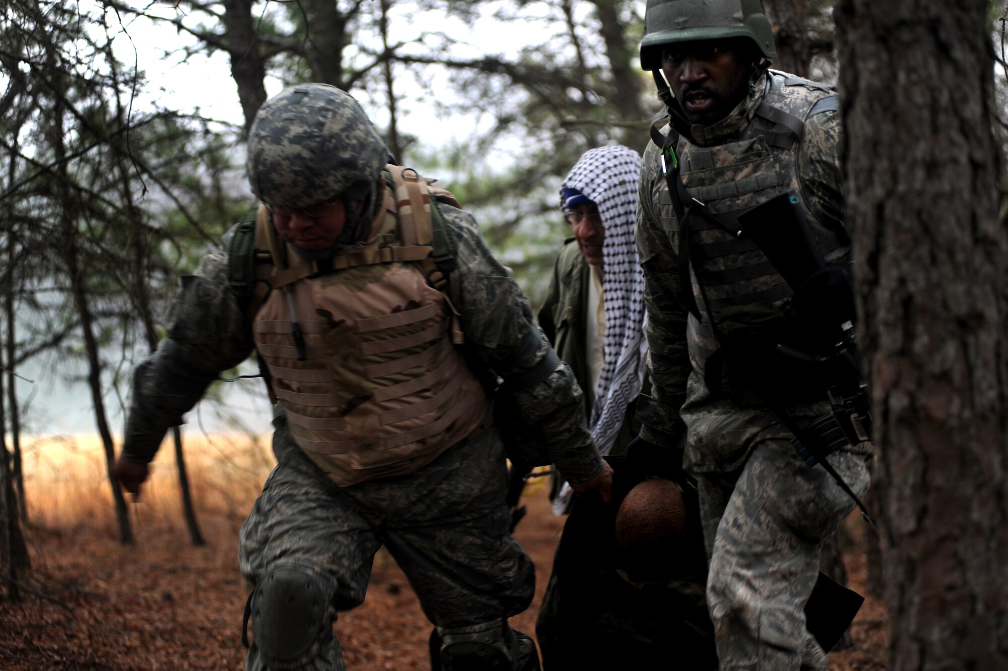 Airmen drag a simulated casualty victim to a combat first aid site during a training scenario on a Fort Dix, N.J. range, March 26, 2009.  The students are in a U.S. Air Force Expeditionary Center's Advanced Contingency Skills Training Course taught by the 421st Combat Training Squadron which prepares Airmen for upcoming deployments with advanced combat skills.   (U.S. Air Force Photo/Staff Sgt. Nathan G. Bevier) 