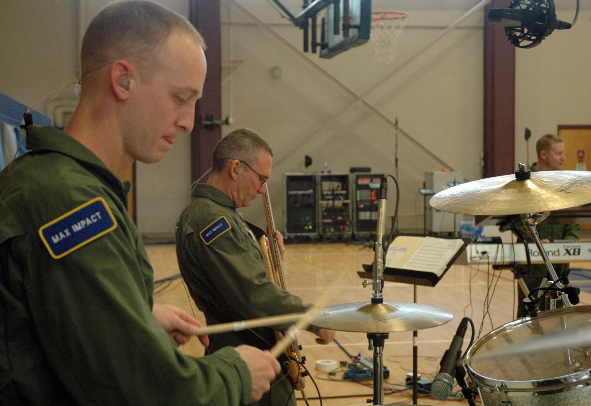 Master Sgt. Dennis Hoffman plays the drums while Master Sgt. Dave Foster strums his bass March 31 during a Max Impact performance March 31 on Maxwell Air Force Base, Ala. (U.S. Air Force photo by Senior Airman R. Michael Longoria)
