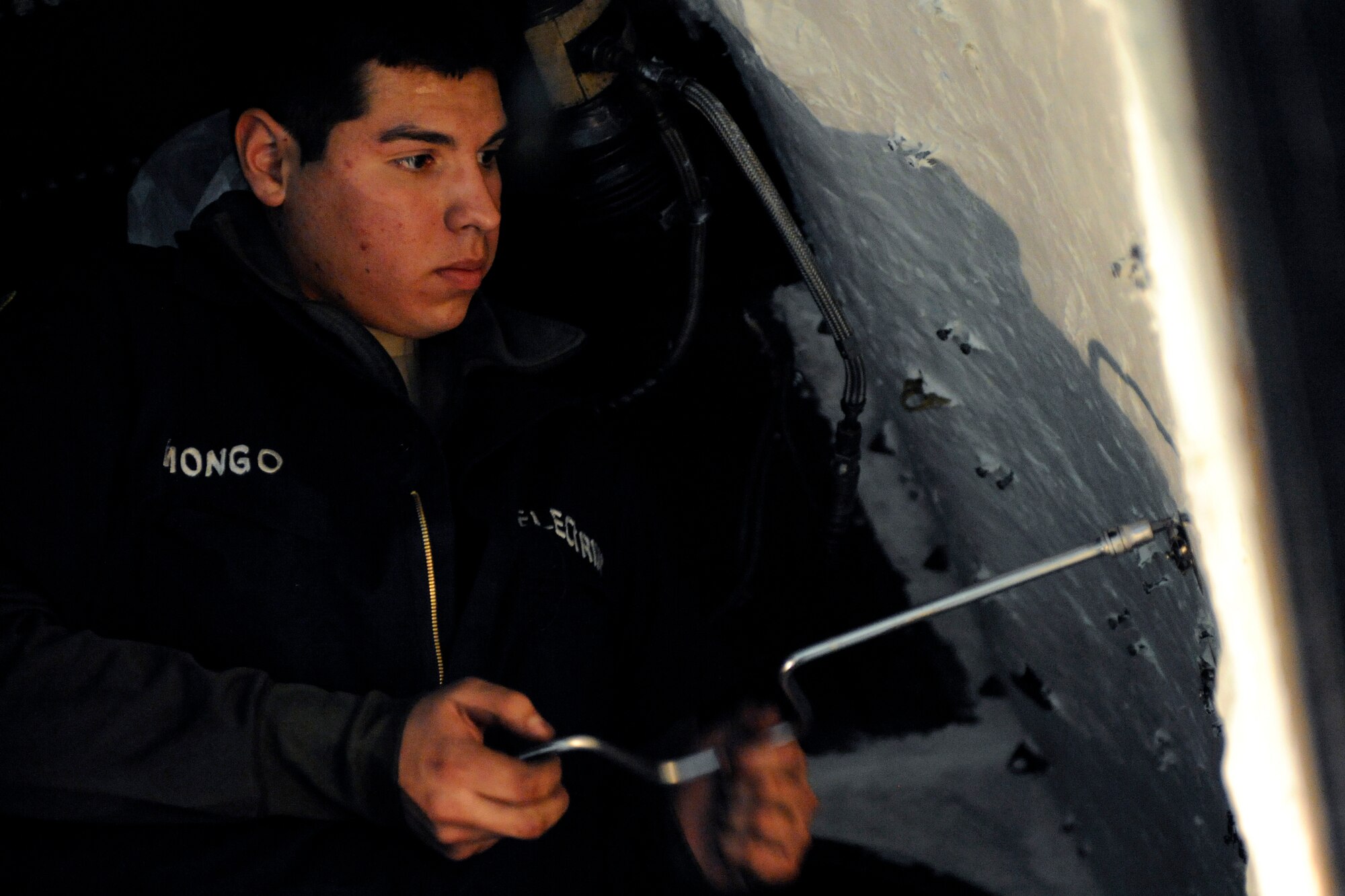 Senior Airman Efstathiou Kostantinos, 28th Maintenance Squadron electrical and environmental technician, installs fire loops in the engine bays of a B-1B Lancer here, April 1. Fire loops are designed to detect fire in the engine bays and alert the aircrew to a fire. (U.S. Air Force photo/Airman 1st Class Matthew Flynn)
