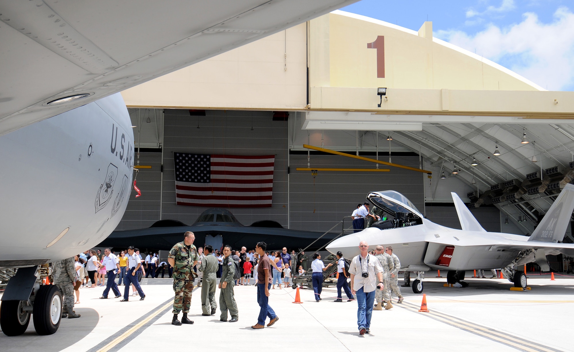 Spectators explore aircraft during the March 28 open house at the Andersen Air Force Base, Guam. The event showcased the fire unit, explosive ordnance disposal unit, a K-9 unit, a KC-135 Stratotanker, an F-22 Raptor, and a B-2 Spirit. (U.S. Air Force photo/Airman 1st Class Courtney Witt) 
