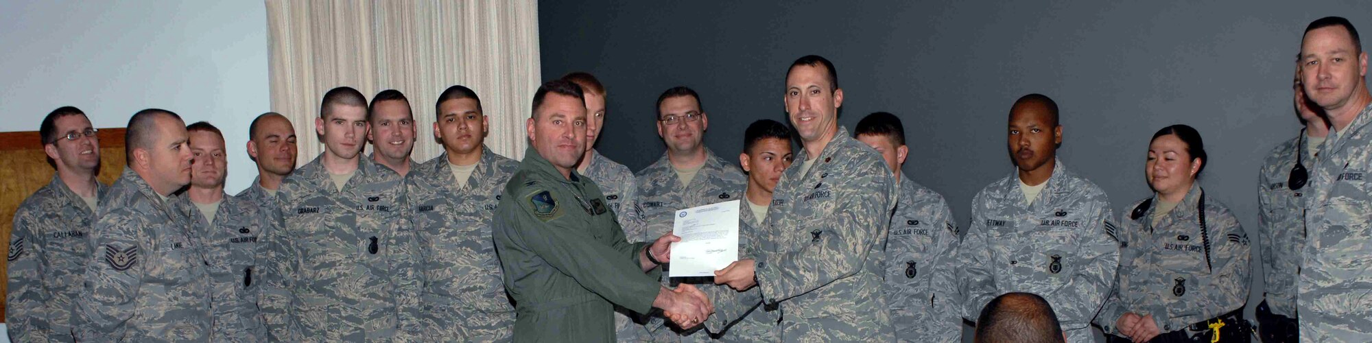 CANNON AIR FORCE BASE, N.M. -- The 27th Special Operations Security Forces Squadron, receives the 2008 Air Force Special Operations Command Best Medium Security Forces Unit awards presented by Col. Timothy Leahy, 27th Special Operations Wing commander. The 27 SOSFS received the award at the weekly wing staff meeting on March 31.  (U.S. Air Force Photo/ Airman 1st Class James Bell)