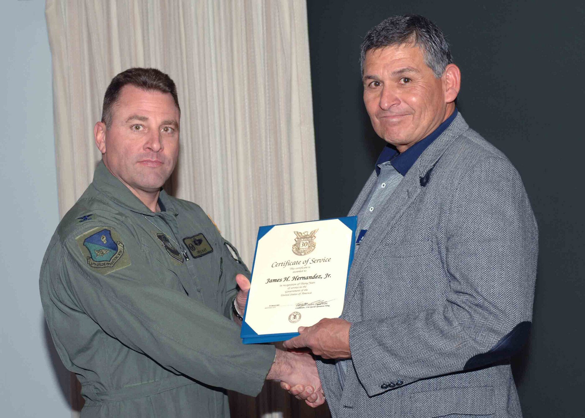 CANNON AIR FORCE BASE, N.M. -- Mr. James Hernandez, 27th Special Operations Force Support Squadron, receives the 30-Year Service Award presented by Col. Timothy Leahy, 27th Special Operations Wing commander.  Mr. Hernandez received the award at the weekly wing staff meeting on March 31.  (U.S. Air Force Photo/ Airman 1st Class James Bell)