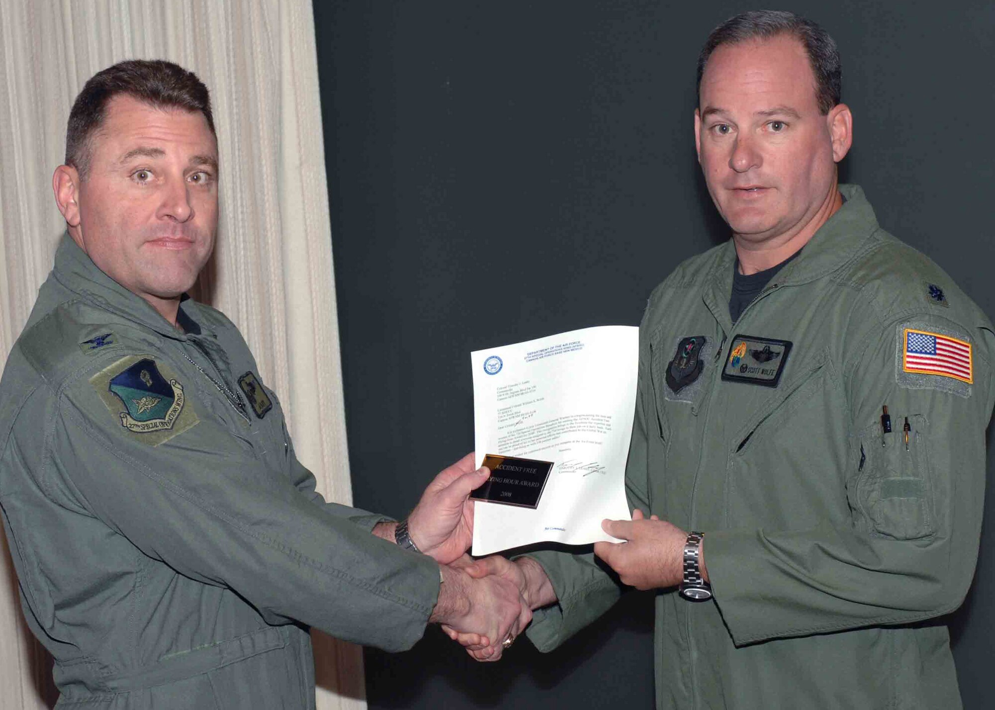 CANNON AIR FORCE BASE, N.M. -- Lt. Col. Scott Wolfe, 73rd Special Operations Squadron commander, receives the 2008 Air Force Special Operations Command Accident-Free- Flying Hour Award presented by Col. Timothy Leahy, 27th Special Operations Wing commander. The 73 SOS received the award at the weekly wing staff meeting on March 31. (U.S. Air Force Photo/ Airman 1st Class James Bell)