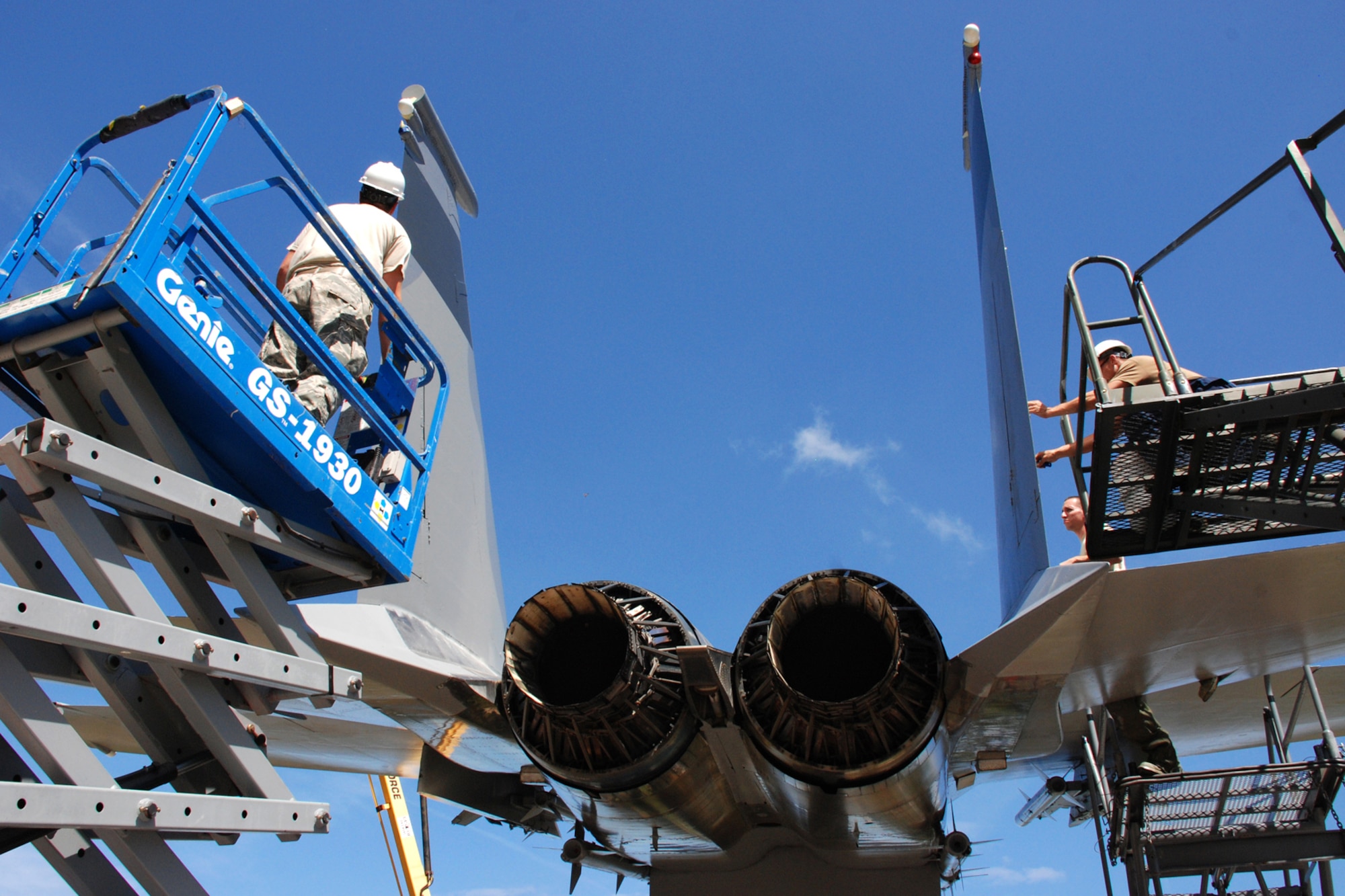 EGLIN AIR FORCE BASE, Fla. -- Staff Sgt. Kyle Sichting (left) and Senior Airmen Larry Sports and Curtis Deleon, 33rd Maintenance Squadron, restore the paint and decals on the vertical stabilizers of the F-15 Eagle static display on Eglin Blvd., March 24. (U.S. Air Force photo/Staff Sgt. Mike Meares)