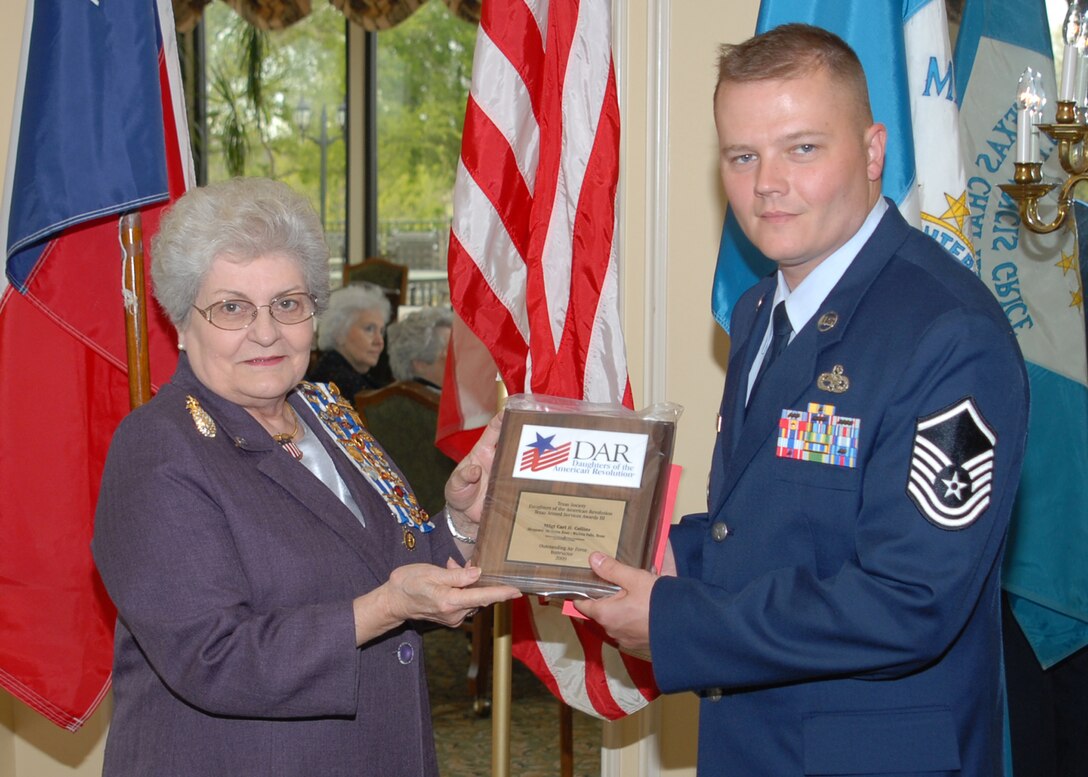 Daughters of the American Revolution Division 2 Chairman,  Margaret Jones, presents one of four Sheppard Technical Training Instructor Awards to Master Sgt.Carl Collins.  He is an aerospace ground equipment craftsman, assigned to the 361st Training Squadron at Sheppard. (U.S. Air Force photo/LouAnne Sledge)