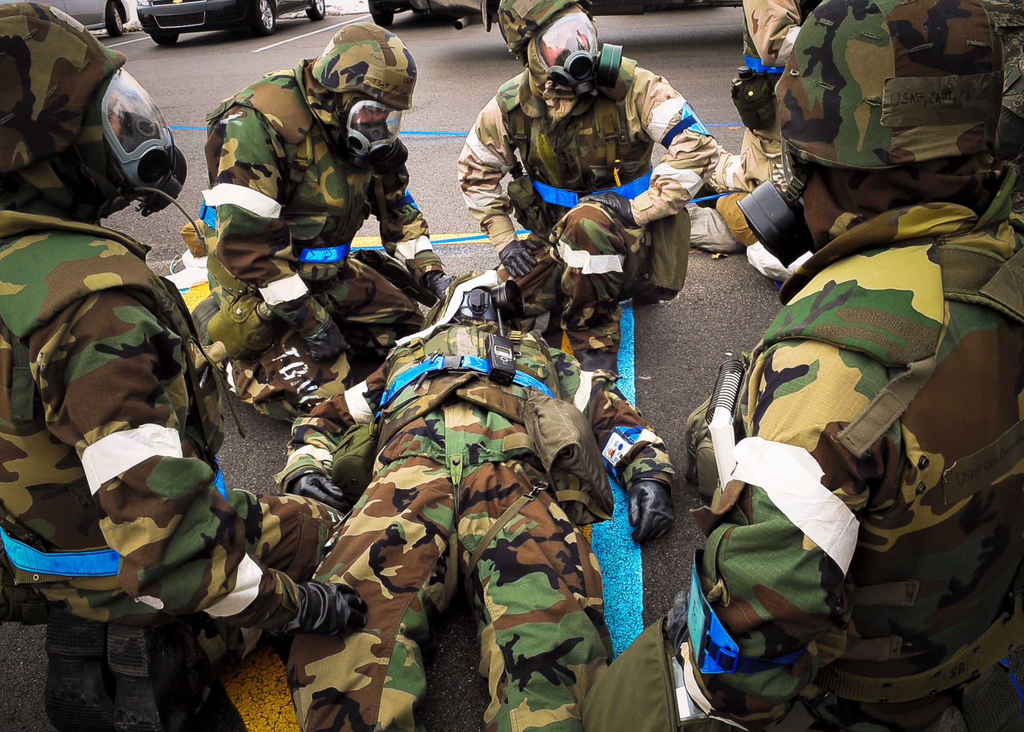 ALPENA, Mich.–Teammates crowd around a wounded Airman after a simulated explosion took place during an Operational Readiness Inspection here March 26. The Airmen, all from Fairchild Air Force Base, Wash., were demonstrating proficiency in self aid buddy care for the inspectors. (U.S. Air Force photo / Senior Airman Joshua K. Chapman)