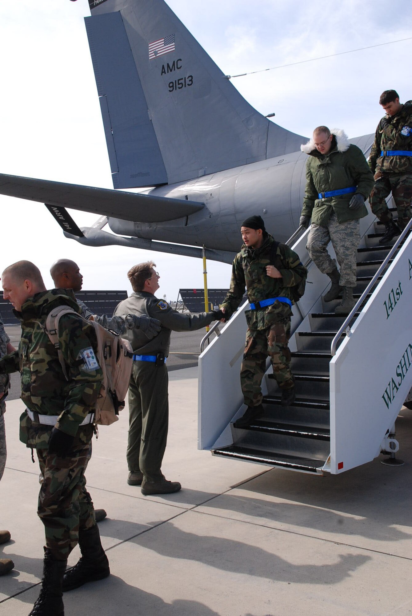 Members of Team Fairchild are greeted by commanders as they unload from a KC-135 returning from Alpena, Mich., March 27 following a 3-day demonstration of our capabilities to the inspectors for the Operational Readiness Inspection. (U.S. Air Force photo/Senior Airman Emerald Ralston)