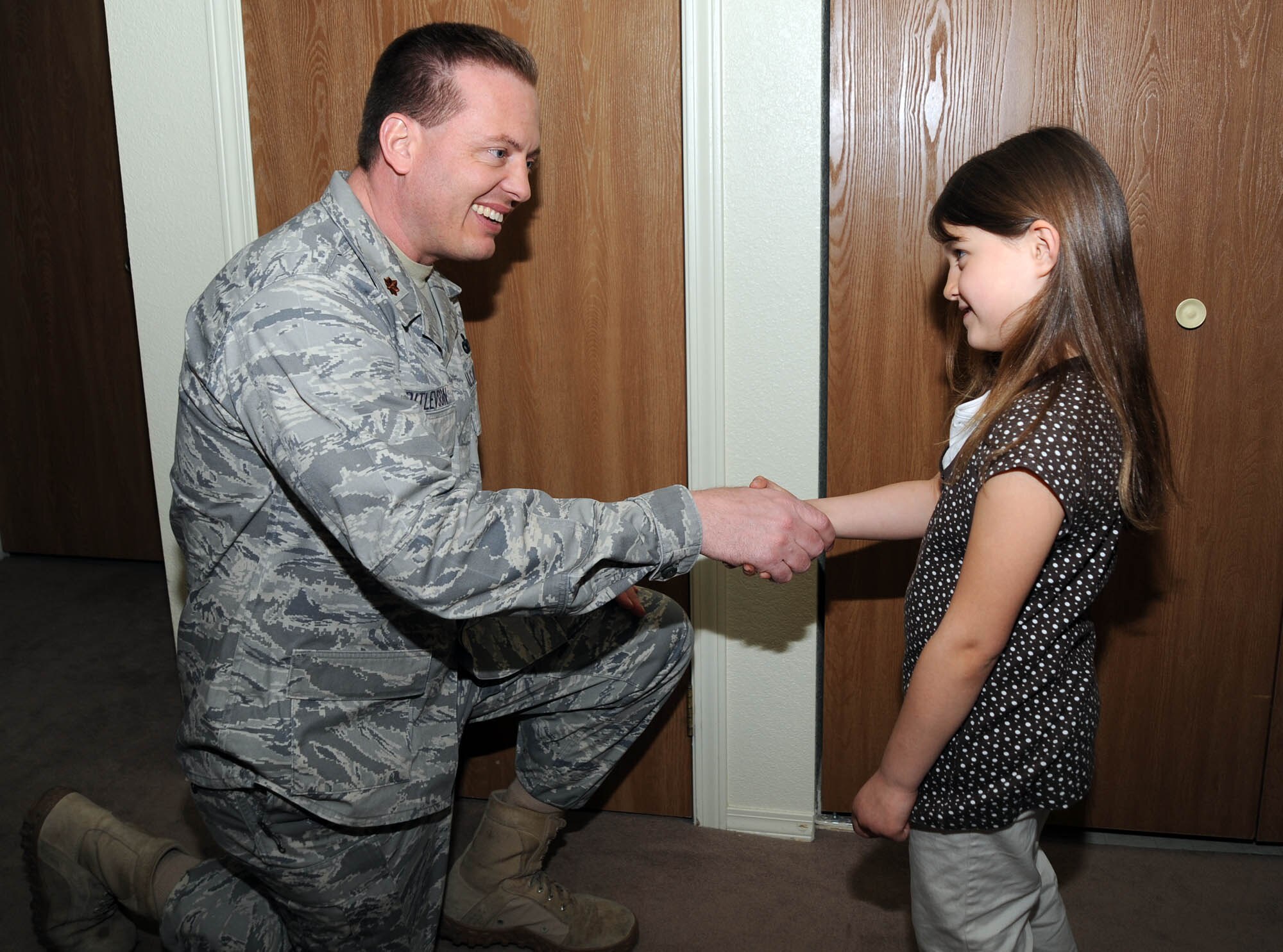 Maj. Jeffery Ditlevson, 92nd Security Forces  Squadron commander, coins 6-year-old Jocelyn Gianoli March 26. Jocelyn came to the aid of her mother and alerted neighbors of her the medical condition. Maj. Ditlevson, 92nd SFS, recognized her bravery and courage by presenting the coin. (U.S. Air Force photo / Staff Sgt JT May III)