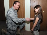 Maj. Jeffery Ditlevson, 92nd Security Forces  Squadron commander, coins 6-year-old Jocelyn Gianoli March 26. Jocelyn came to the aid of her mother and alerted neighbors of her the medical condition. Maj. Ditlevson, 92nd SFS, recognized her bravery and courage by presenting the coin. (U.S. Air Force photo / Staff Sgt JT May III)