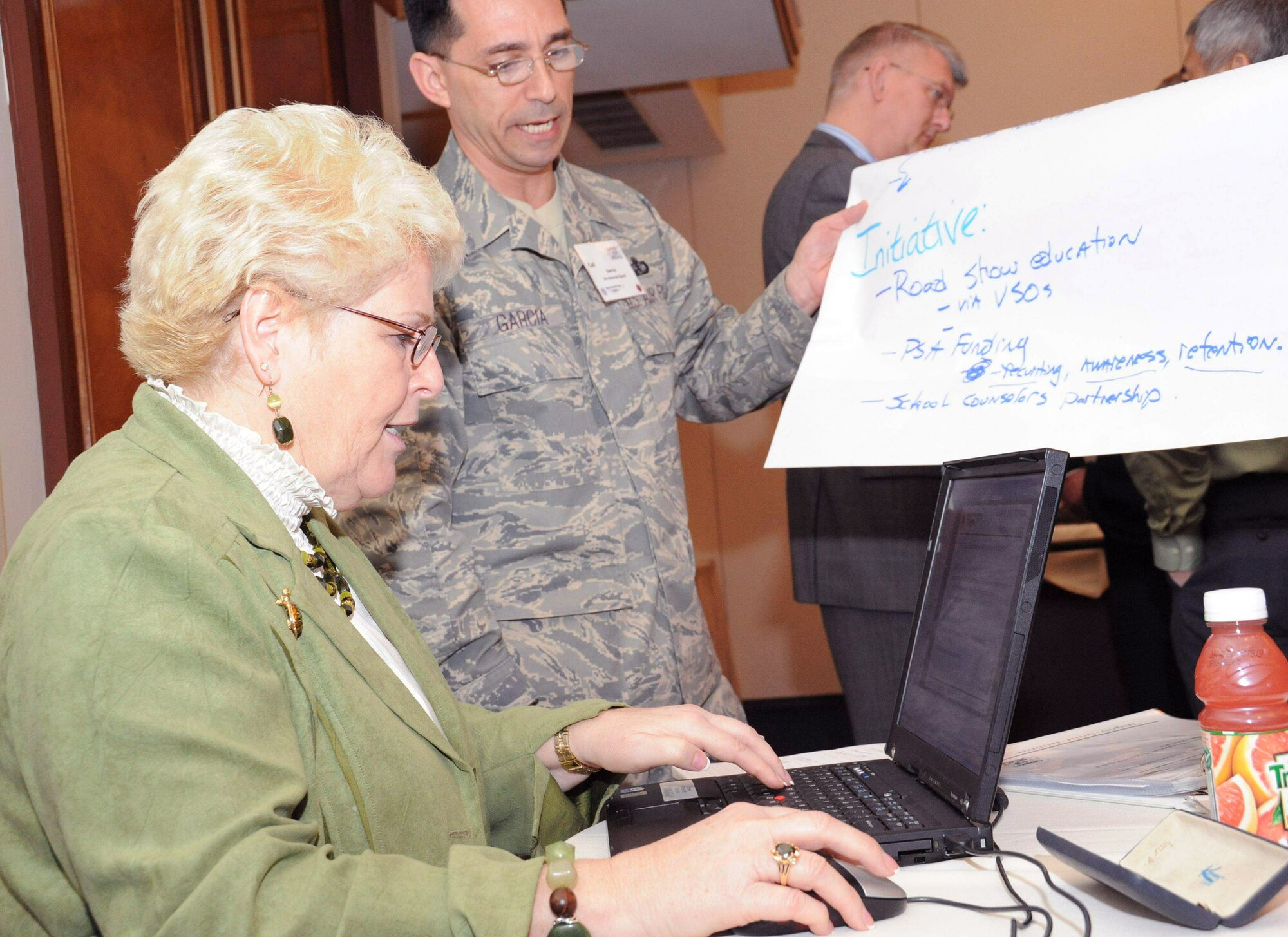 Nancy Brewer records theme ideas from Senior Master Sgt. Cali Garcia during a working group session at the Year of the Air Force Family: Caring for People Forum April 1 at Arlington, Va. The 28-person group developed the themes and will use the best to develop initiatives focusing on support for Air National Guard and Reserve family members. Mrs. Brewer is from Peterson Air Force Base, Colo., and is the chief of Airman and Family Quality of Life for Air Force Space Command. Sergeant Garcia is the air field liaison for the National Guard Bureau J1 Family Program in Arlington. (U.S. Air Force photo/Staff Sgt. Patrick Brown) 
