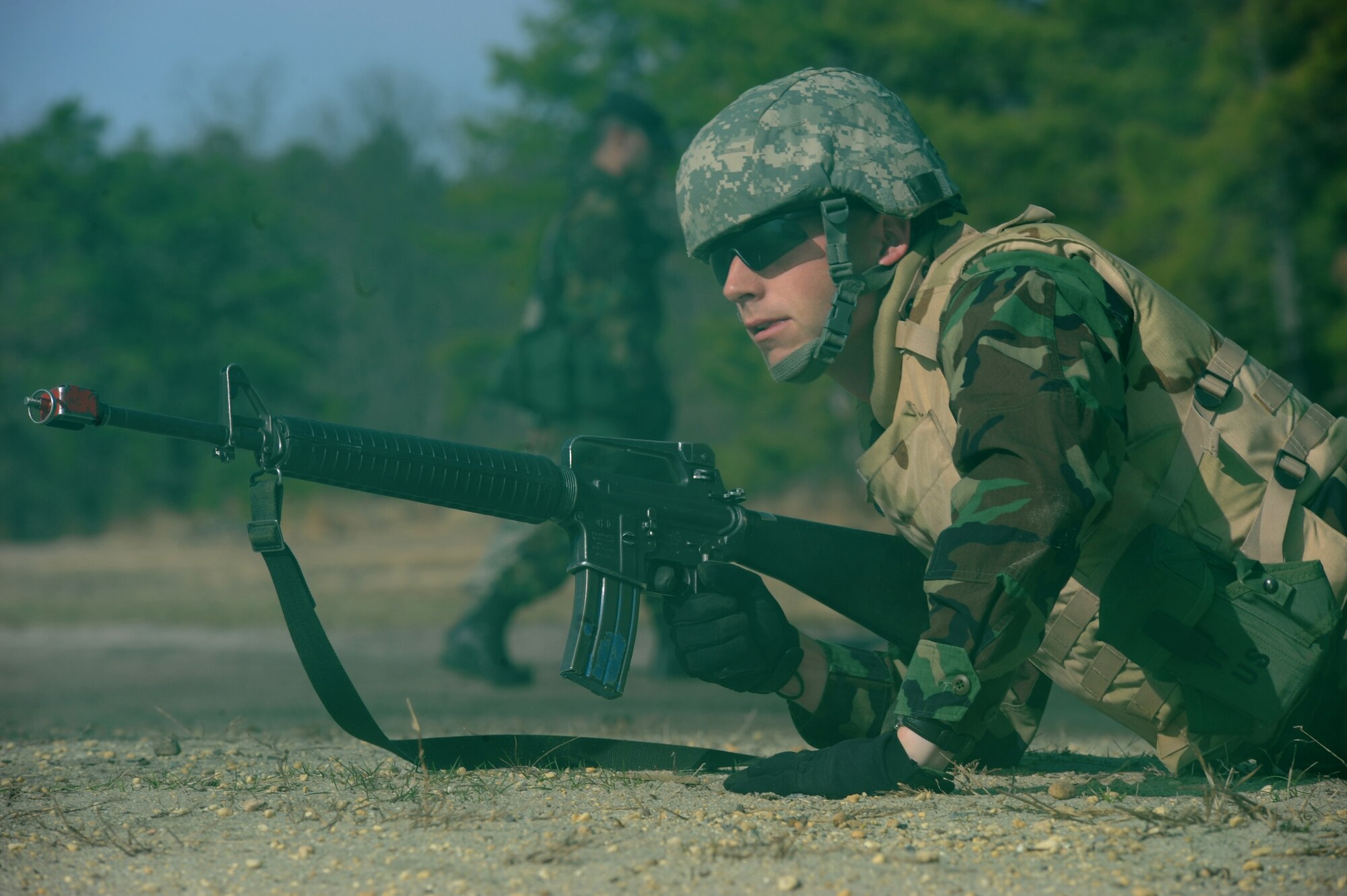 An Airman positions himself to protect his fellow Airmen after a HUMVEE drove over a controlled improvised explosive during convoy operations training on a Fort Dix, N.J. range, March 31, 2009.  The students are in a U.S. Air Force Expeditionary Center's Advanced Contingency Skills Training Course taught by the 421st Combat Training Squadron which prepares Airmen for upcoming deployments with advanced combat skills.   (U.S. Air Force Photo/Staff Sgt. Nathan G. Bevier) 