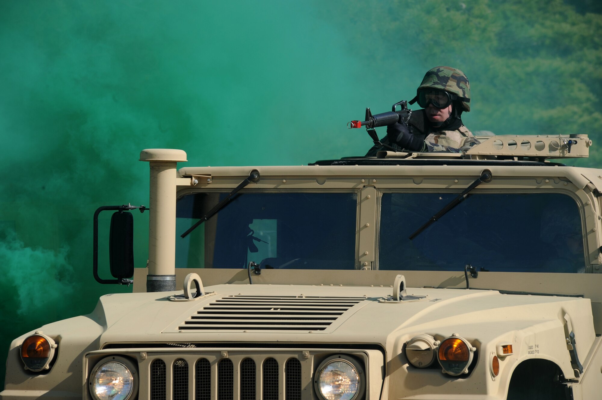 A gunner surveys the surrounding area after his HUMVEE drove over a controlled improvised explosive during convoy operations training on a Fort Dix, N.J. range, March 31, 2009.  The students are in a U.S. Air Force Expeditionary Center's Advanced Contingency Skills Training Course taught by the 421st Combat Training Squadron which prepares Airmen for upcoming deployments with advanced combat skills.   (U.S. Air Force Photo/Staff Sgt. Nathan G. Bevier) 
