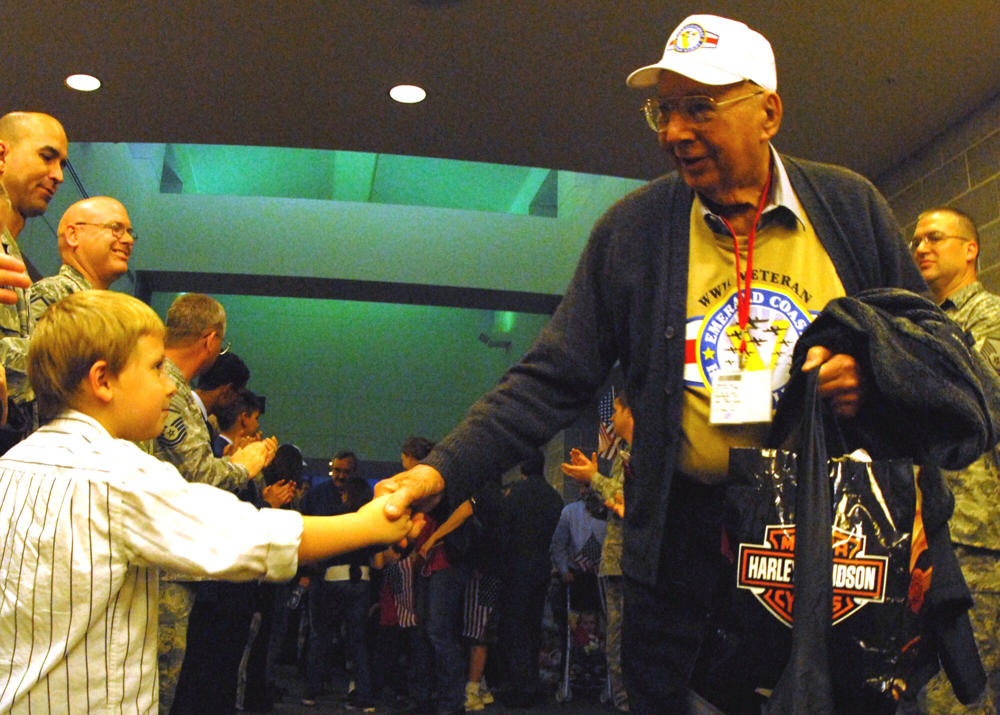 Conner Dupree greets one of the 103 World War II veterans returning from the 3rd annual Honor Flight April 1.  Conner’s mother Stephanie, a local nurse, volunteered as a “guardian” for the flight.  The veterans left Florida in the morning to spend the day in Washington and visit the World War II memorial before returning to a hero’s welcome.  More than 200 military members lined the concourse to greet the veterans and their family as they exited.  Children and adults greeted them with flags and signs while bands played.  U.S. Air Force photo/ Samuel King Jr.