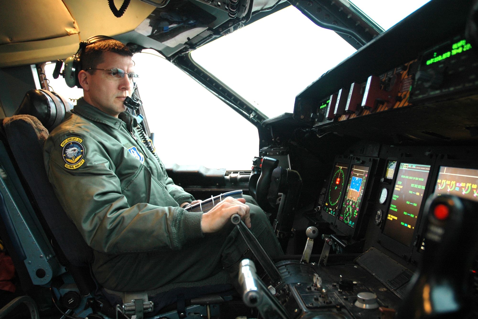 Master Sgt. John Witzke, 709th Airlift Squadron flight engineer, inspects cockpit controls during a pre-flight inspection prior to flying a mission in March. The C-5 flying squadron will be losing many flight engineers due to upcoming retirements and is looking for a few good Airmen to cross train into the career field. (U.S. Air Force photo/Senior Airman Deb Robinson)