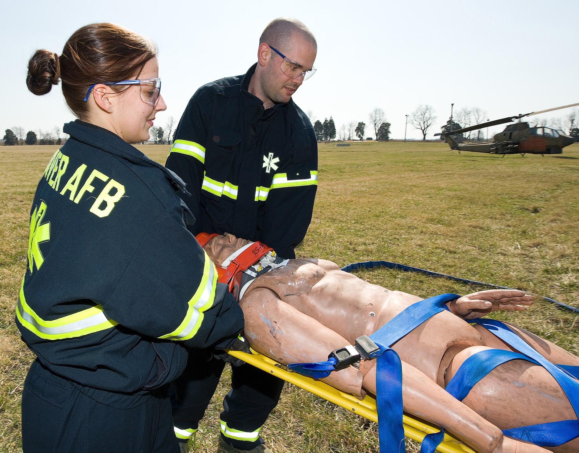 (Left to right) Ambulance response team members Staff Sgt. Jennifer Hull, 436th Medical Operations Support Squadron, and Airman 1st Class Jacob Porter, 436th Medical Support Squadron, carry a litter patient into the ambulance during the exercise March 18. (U.S. Air Force photo/ Roland Balik)