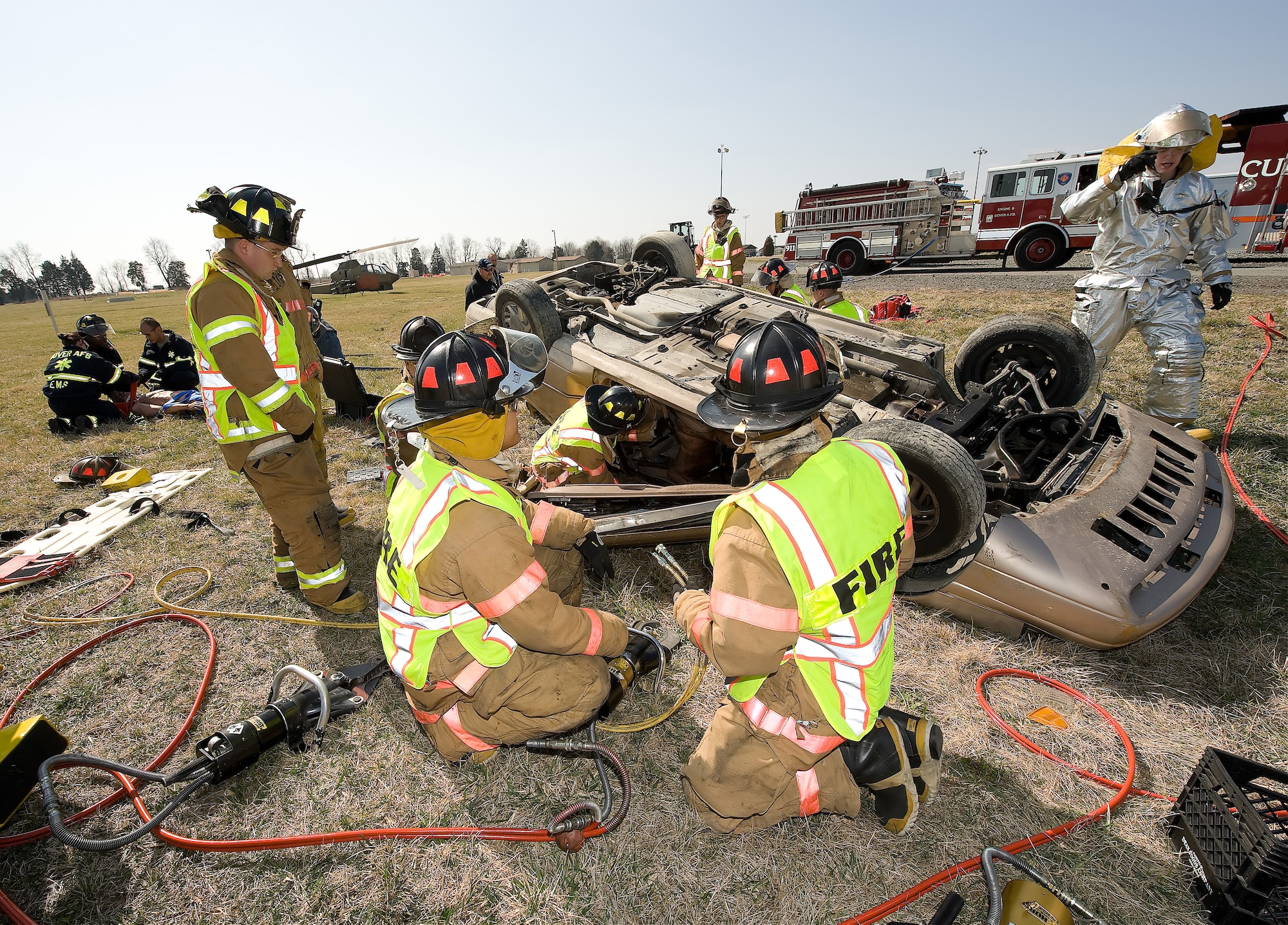 436th Civil Engineer Squadron firefighters try to access a vehicle to rescue a simulated victim during an auto extrication exercise March 18. (U.S. Air Force photo/ Jason Minto)