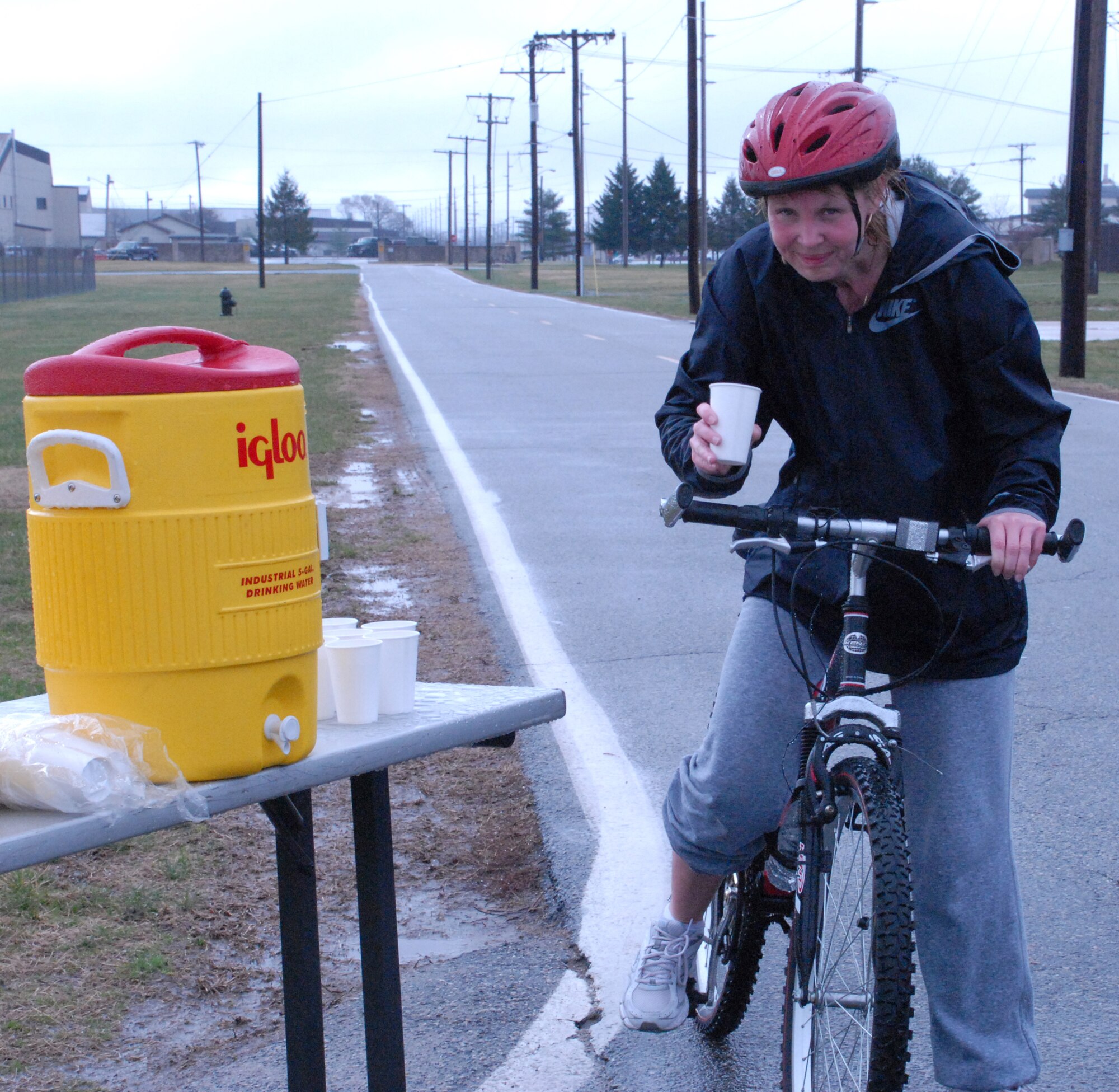 Master Sgt. Janet Lightburn, 436th Aerospace Medicine Squadron, stops for a quick water-break during the 10.6 mile bike ride portion of Dover?s Duathlon March 28 hosted by the Fitness Center. (U.S. Air Force photo/Airman 1st Class Shen-Chia Chu)