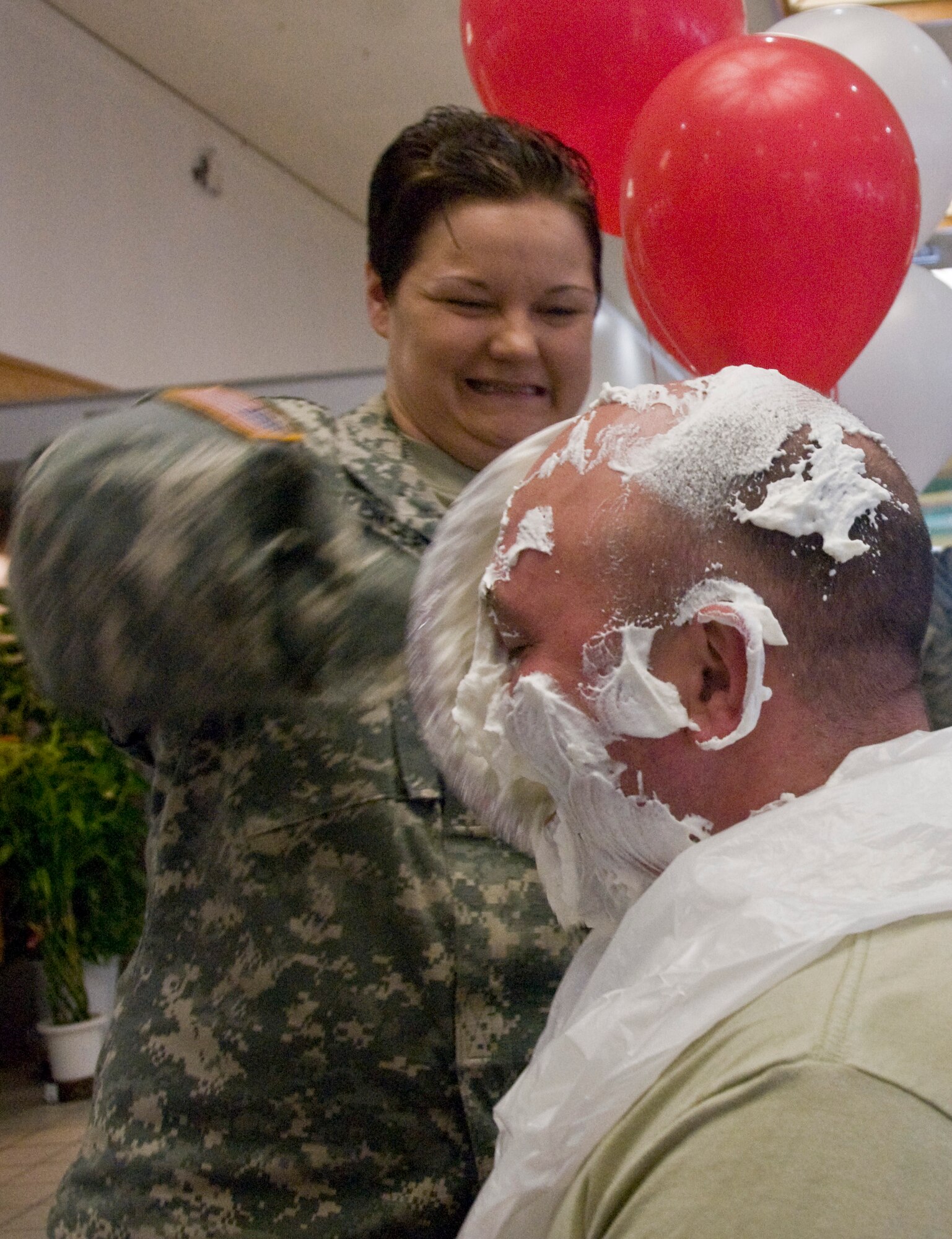 MISAWA AIR BASE, Japan -- Army Staff Sgt. Tina Spencer, 403rd Military Intelligence Army Detachment, hits Army Chief Warrant Officer Jason Slater, 403rd MI Army Detachment, with a pie in the face April 1, 2009. Army, Navy and Air Force first sergeants challenged their units to donate money in their names in an effort to raise funds for the American Red Cross. (U.S. Air Force photo by Staff Sgt. Araceli Alarcon)