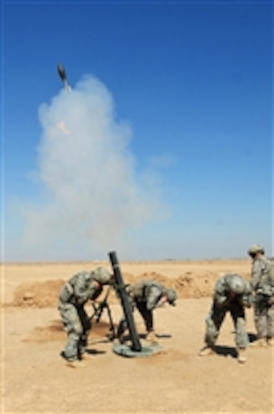 U.S. Army soldiers from Delta Company, 1st Battalion, 63rd Armor Regiment, 3rd Brigade Combat Team, 1st Infantry Division fire an M120 120mm mortar system during training for Iraqi soldiers in Mahmadiyah, Iraq, on March 26, 2009.  
