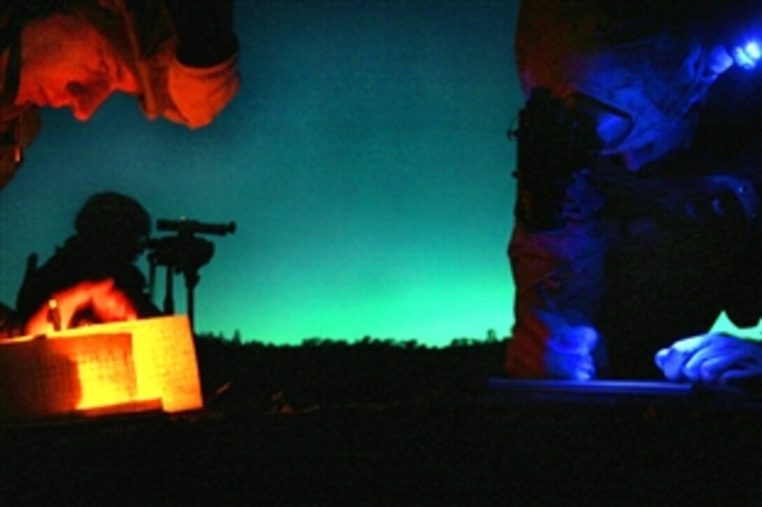 U.S. Marine Corps Maj. Brent Johnson, left, and Capt. Jonathan Marang coordinate target information prior to calling in close air support during an exercise on Fort Hunter Ligget, Calif., March 29, 2009. Johnson and Marang are assigned to the 11th Marine Expeditionary Unit.