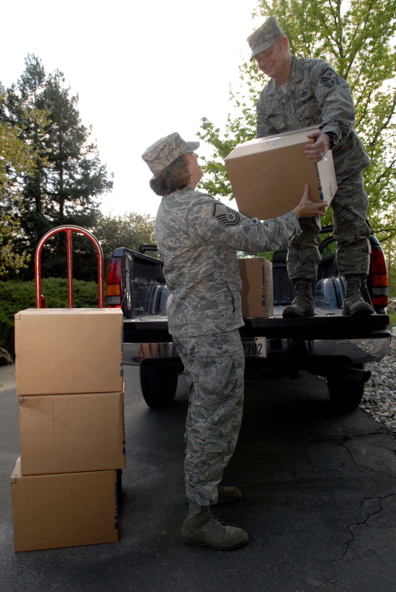 SACRAMENTO, Calif. -- Master Sgt. Tracy Tolliver, the 30th Force Support Squadron first sergeant, along with Master Sgt. Paul Barker, a first sergeant from the 30th Medical Group, unload boxes full of shoes in support of the Shoes to Share program April 2. The shoes are sent to villagers and students residing in the Hwange region of Zimbabwe. Approximately 50 boxes were donated by Vandenberg’s local community. (U.S. Air Force photo/Senior Airman Christian Thomas)