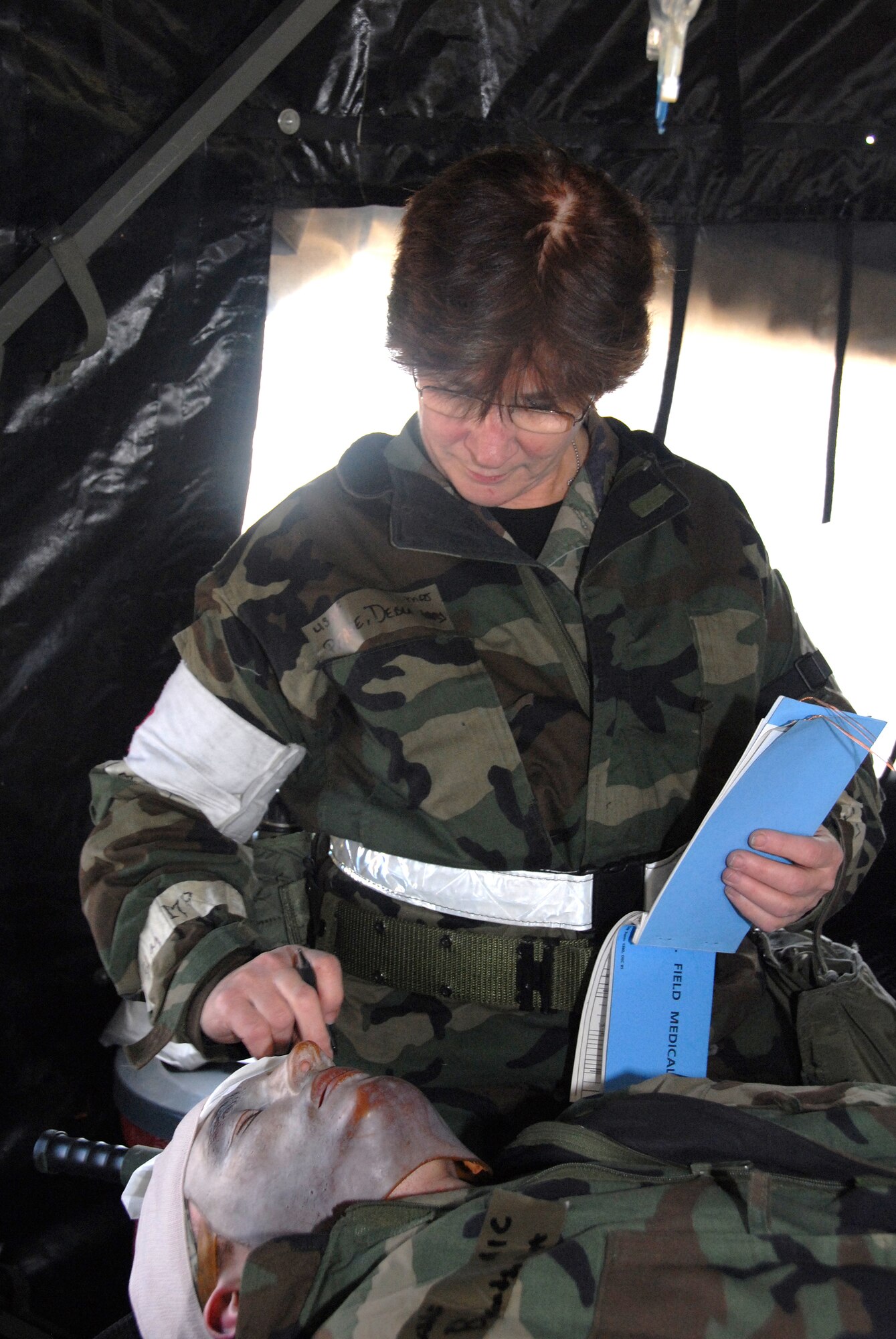 442nd Medical Squadron officer, Maj. Debra Pease, chief nurse, assesses Airman 1st Class Matthew Bounds' head injury as she prepares him for treatment. To add a sense of realism, moulages that mimic real wounds or injuries are used.The 442nd MDS is part of the 442nd Fighter Wing, an Air Force Reserve Command A-10 Thunderbolt II unit based at Whiteman Air Force Base, Mo. (US Air Force photo/Senior Airman Dani Wolf)