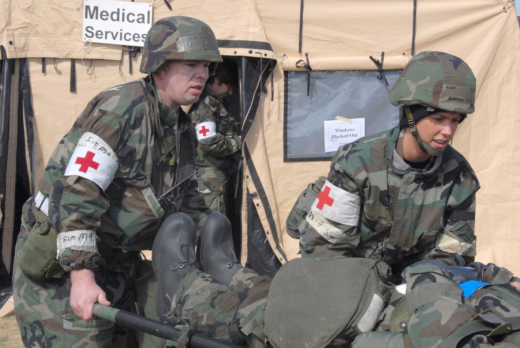 Two 442nd Medical Squadron medical technicians, Tech. Sgt. Greg Stephens and Staff Sgt. Callie Brockman, help carry a litter with an 'injured' Airman to the medical services tent during an Operational Readiness Exercise here.  The medics treated a variety of simulated injuries and wounds during the two-day exercise and often had to respond in their full chemical warfare protection clothing. The 442nd MDS is part of the 442nd Fighter Wing, an Air Force Reserve Command A-10 Thunderbolt II unit based at Whiteman Air Force Base, Mo. (US Air Force photo/Senior Airman Dani Wolf)