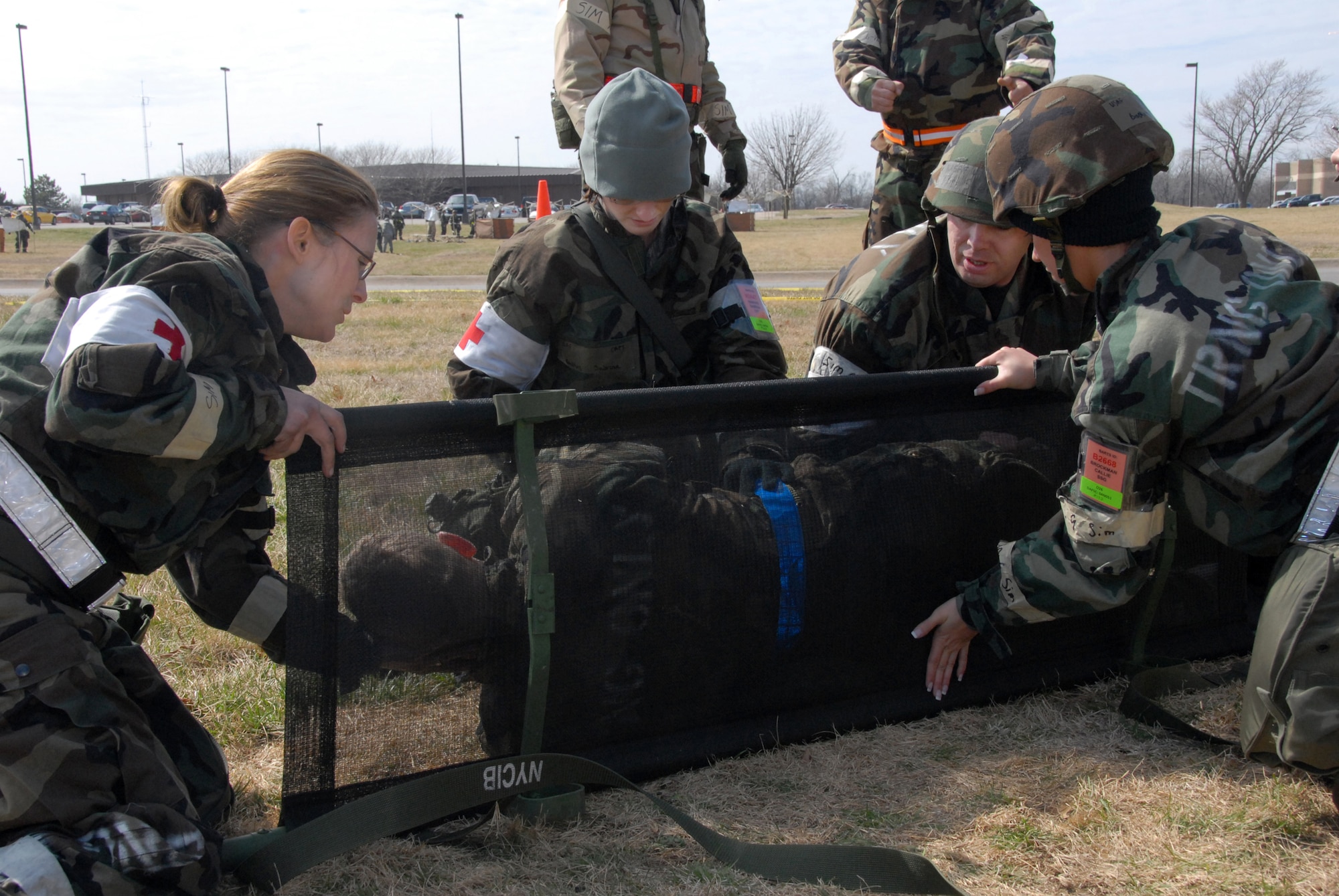 Four Airmen from the 442nd Medical Squadron, Capt. Jennifer Conley, Capt. Sabrina Hawkins, Tech. Sgt. Greg Stephens and Staff Sgt. Callie Brockman, roll Tech. Sgt. James Young, simulated victim, onto a litter. The 442nd MDS is part of the 442nd Fighter Wing, an Air Force Reserve Command A-10 Thunderbolt II unit based at Whiteman Air Force Base, Mo. (US Air Force photo/Senior Airman Dani Wolf)