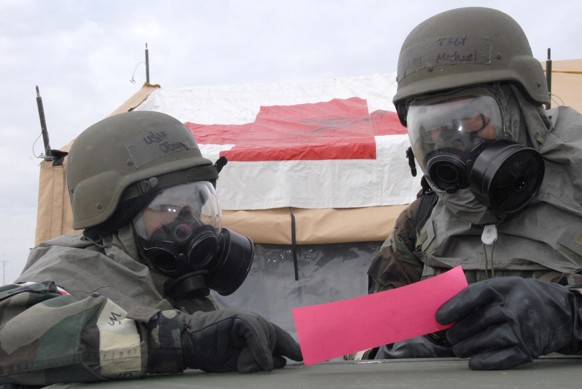 Two Airmen from the 442nd Medical Squadron, Senior Airman Joanne Bedgood and Tech. Sgt. Michael Pratt, discuss an exercise input card presented by exercise evaluation team members during the March Operational Readiness Exercise.The 442nd MDS is part of the 442nd Fighter Wing, an Air Force Reserve Command A-10 Thunderbolt II unit based at Whiteman Air Force Base, Mo. (US Air Force photo/Senior Airman Dani Wolf)