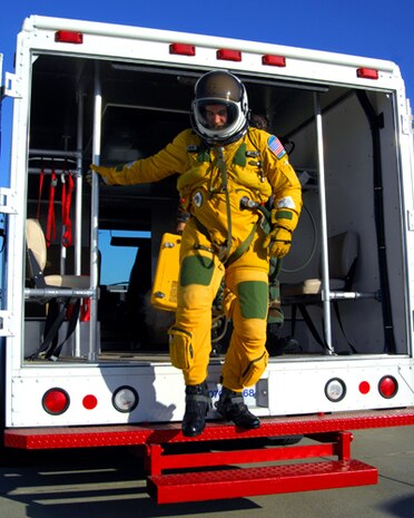 A U-2 Pilot climbs from a transport truck prior to a high-flight. Pilots are suited up and placed on pure oxygen one hour prior to flight. (Photo by Airman 1st Class David Tracy)