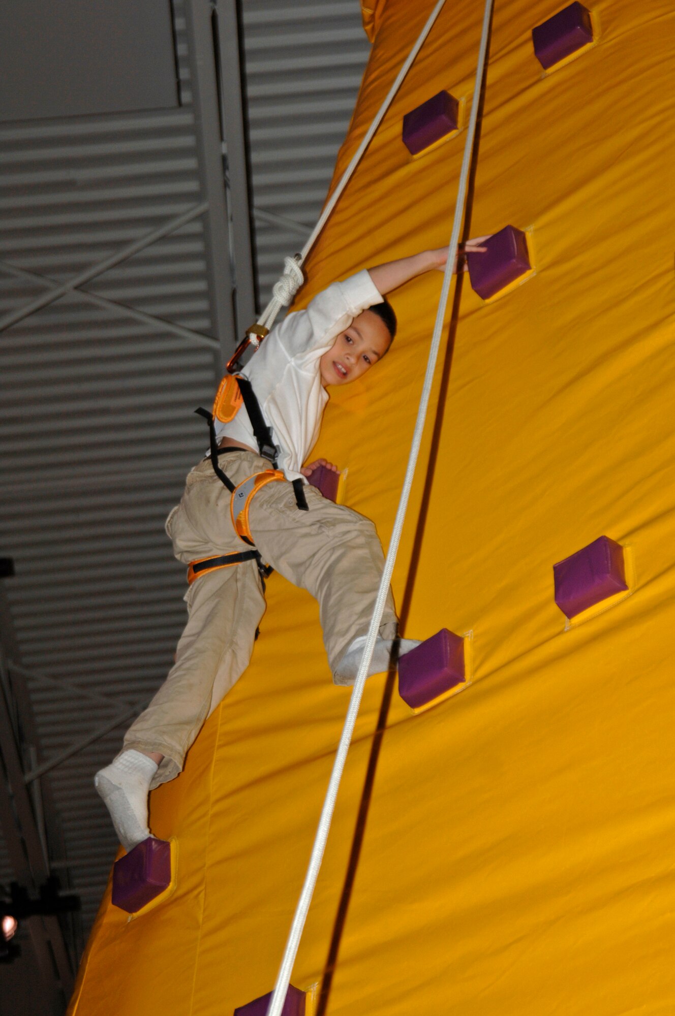 Thoren Jennings, a Team McConnell family member, climbs a king of the mountain inflatable during the 2008 Family Festival of Fun at McConnell Air Force Base, Kan. Inflatable are among the activities scheduled for the the 2009 festival on April 4. (U.S. Air Force photo/Staff Sgt. Ronald Lafosse) 
