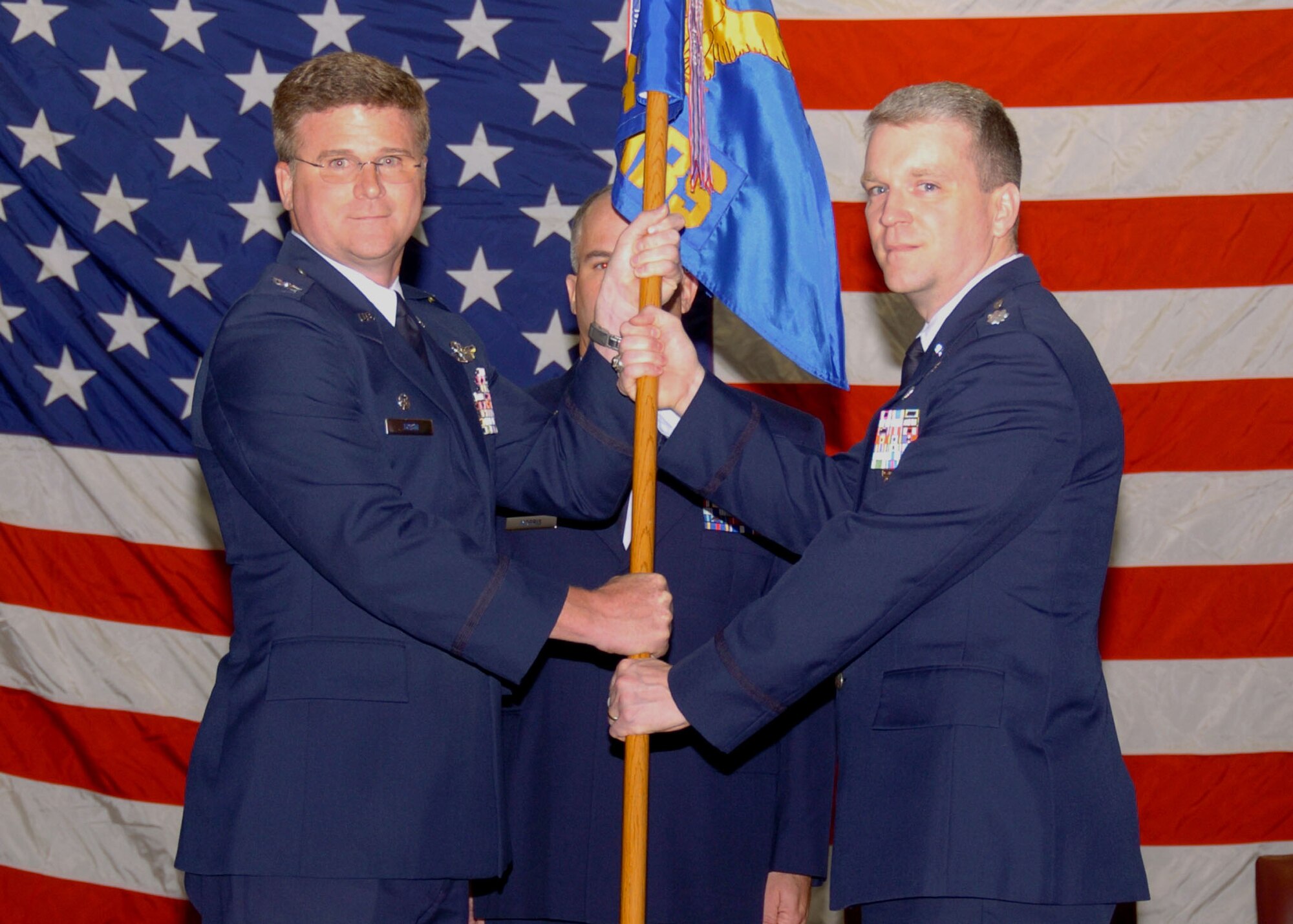 ALTUS AIR FORCE BASE, Okla.-- Col. Keith Tobin, 97th Operations Group commander (left), hands the 54th Air Refueling Squadron guideon to Lt. Col. Thomas Reardon during a change of command ceremony at the Freedom Community Center April 1. Colonel Reardon replaces Lt. Col. Shawn Teagan as the commander of the reformed 54th ARS. (U.S. Air Force photo/Airman 1st Class Tiffany M. Deuel)