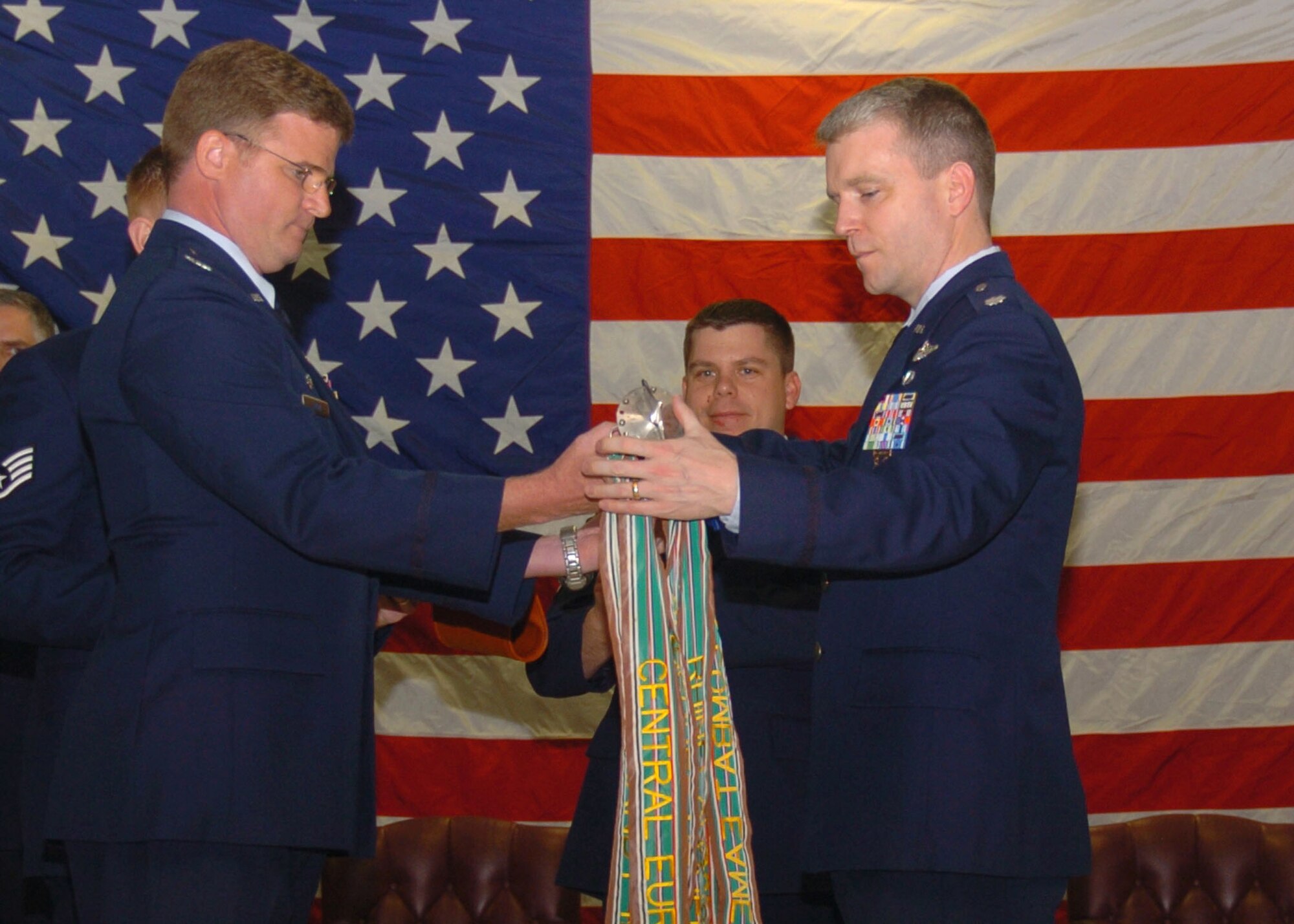 ALTUS AIR FORCE BASE, Okla.-- Col. Keith Tobin, 97th Operations Group commander (left), and Lt. Col. Thomas Reardon, 55th Air Refueling Squadron commander, inactivate the 55th ARS during a change of command ceremony at the Freedom Community Center April 1. After 14 years of service at Altus AFB, the 55th ARS will merge with the 54th ARS. (U.S. Air Force photo/Airman 1st Class Tiffany M. Deuel)

